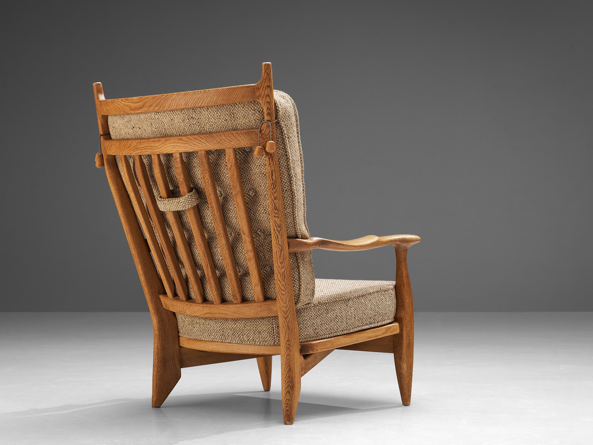 Guillerme et Chambron for Votre Maison, easy chair, oak, fabric, France, 1960s

Guillerme and Chambron are known for their high quality solid oak furniture, of which this two armchair is another great example. This lounge chair has an interesting,