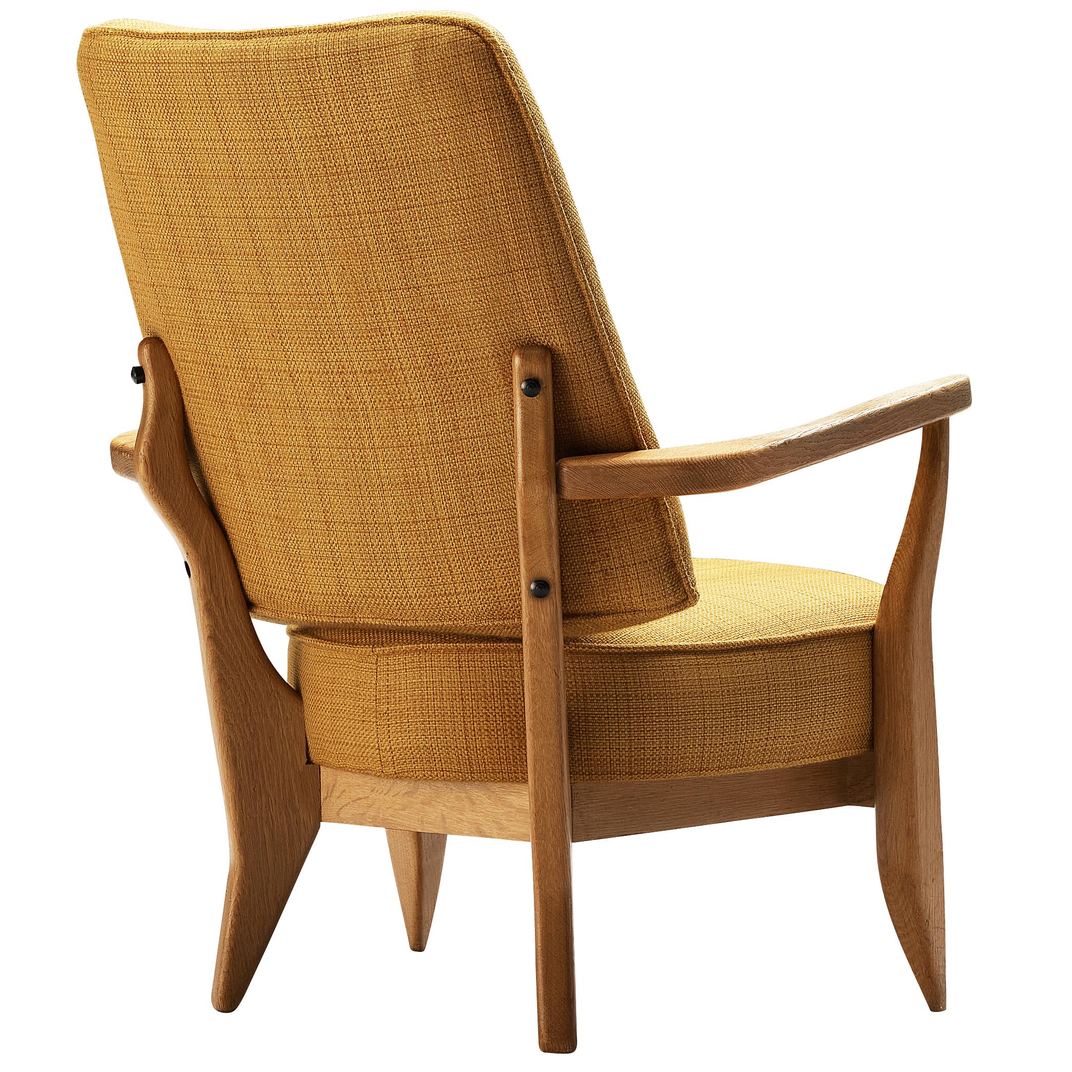 Guillerme et Chambron, easy chair, yellow fabric, oak, France, 1950s 

This sculptural easy chair by Guillerme et Chambron is very well executed and made out of solid, carved oak. The greatly comfortable armchair features an interesting open