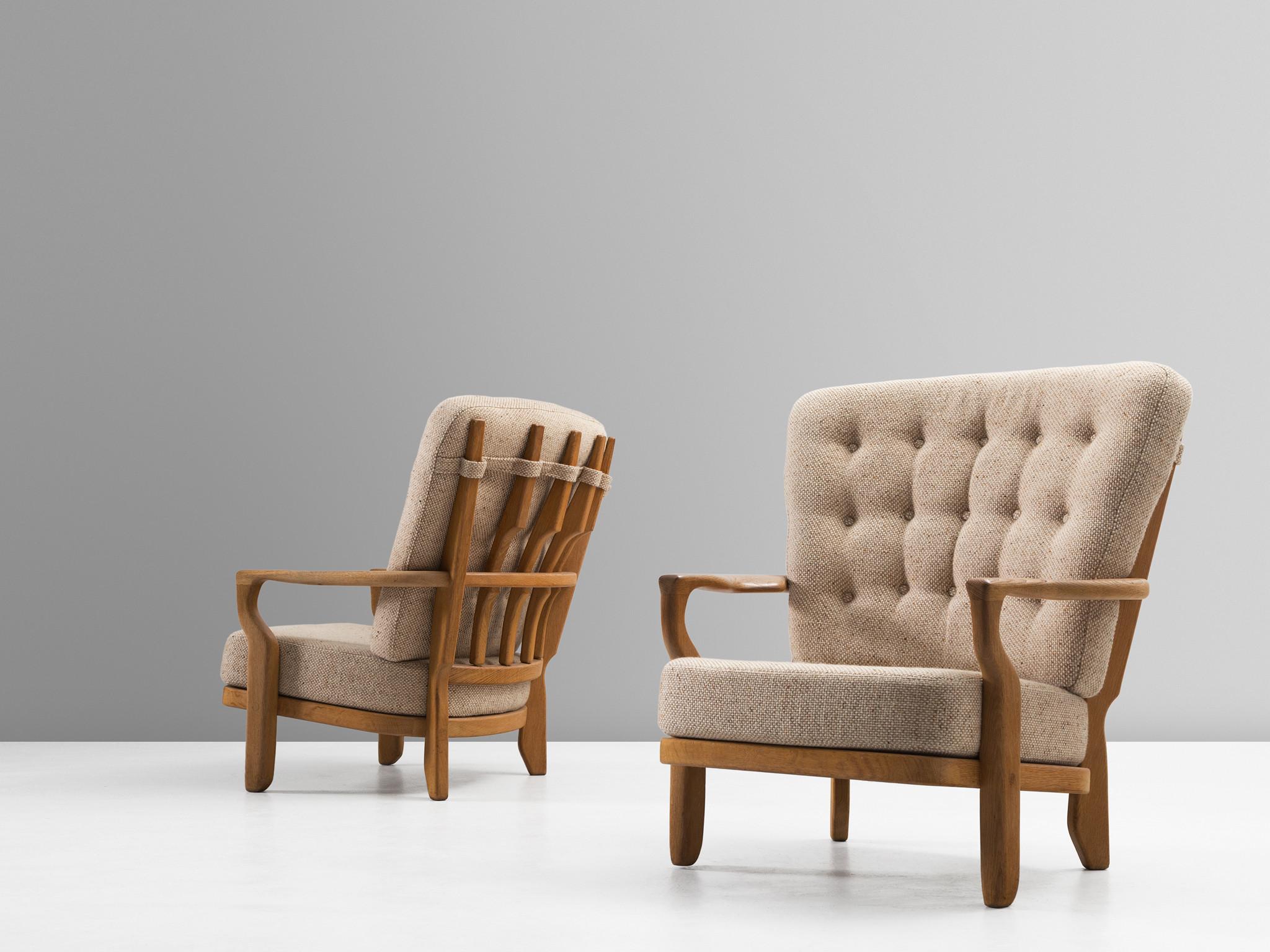 Guillerme et Chambron, lounge chair, in oak and fabric, France, 1960s. 

Extraordinary Guillerme and Chambron armchair, in solid oak with the typical characteristic decorative details at the back and capricious shaped legs. Very comfortable, great