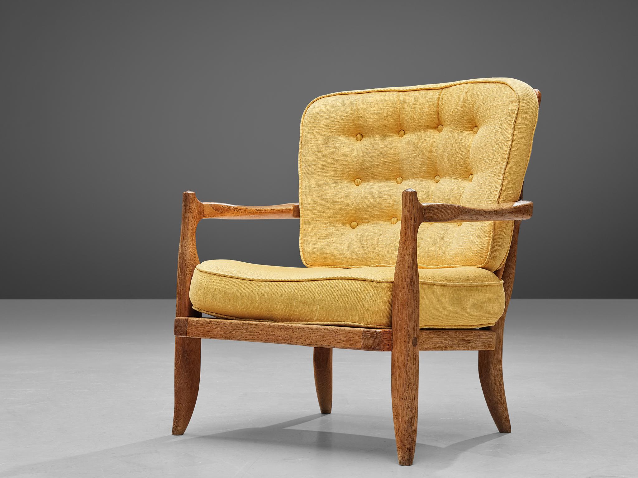 Guillerme et Chambron, lounge chair, oak and yellow upholstery, France, 1960s. 

Well sculpted Guillerme and Chambron lounge chair, in solid oak with the characteristic decorative details at the back and capricious forms of the legs. The