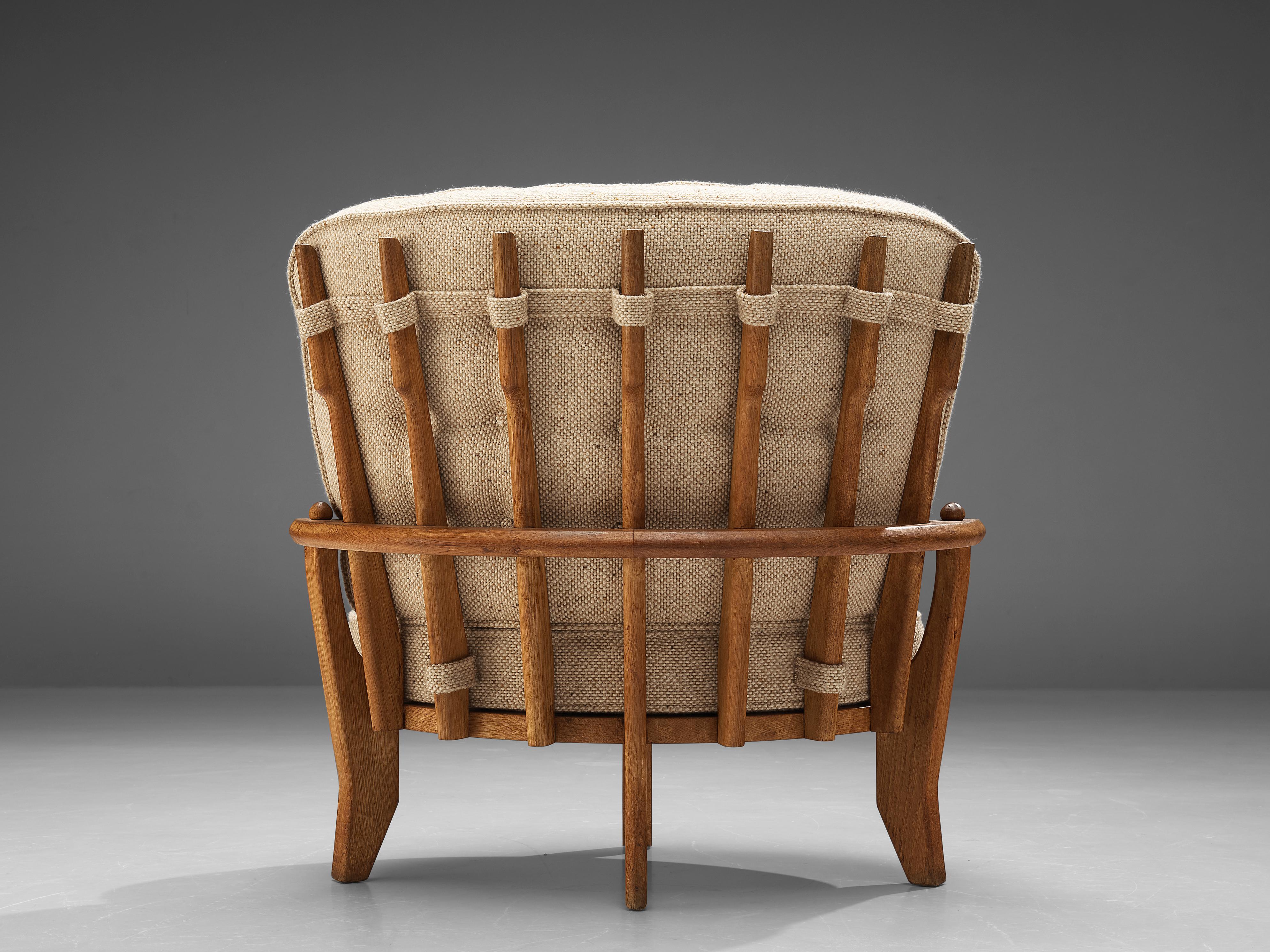 Guillerme & Chambron, lounge chair 'Tricoteuse', oak, fabric upholstery, France, 1960s 

Guillerme et Chambron designed the 'Tricoteuse' lounge chair in solid oak with the typical characteristic decorative details at the back and capricious shaped