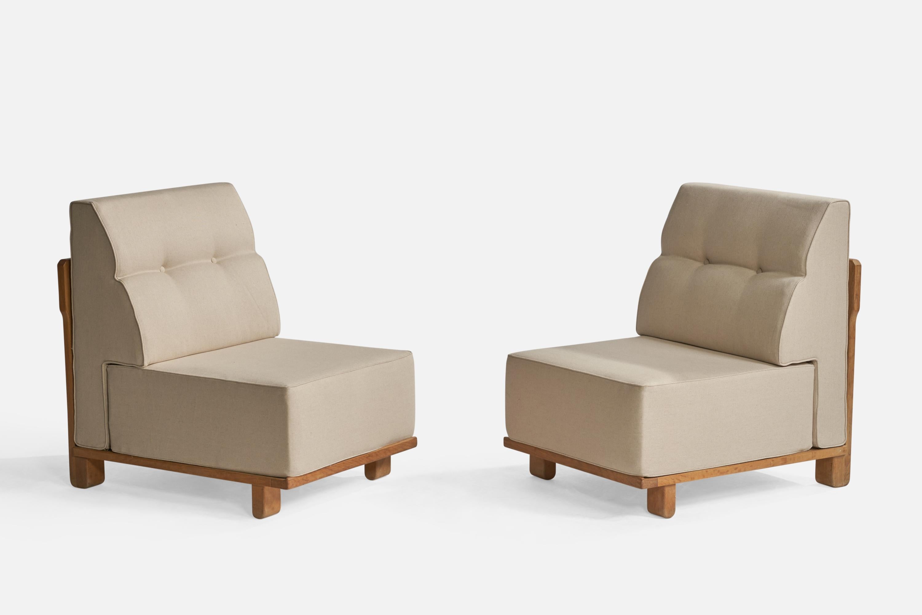 A pair of beige fabric and oak lounge or slipper chairs designed by Robert Guillerme and Jacques Chambron, France, 1950s.

Seat height: 15.5”