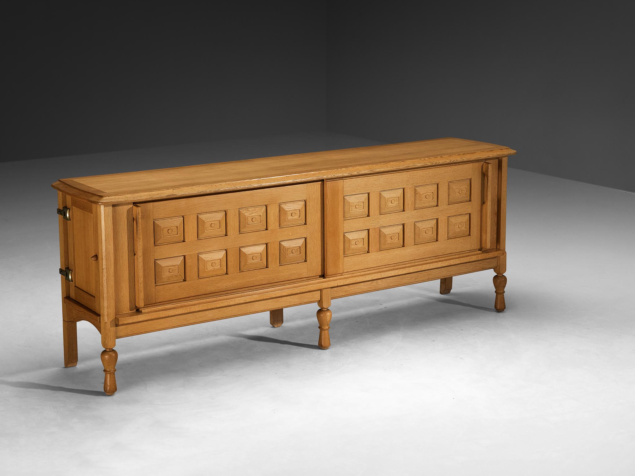 Guillerme et Chambron for Votre Maison, 'Mathias' sideboard, oak, brass, France, 1960s

This outstanding credenza is a design by the French masters Jacques Chambron and Robert Guillerme, dating back to the sixties. Named Mathias, this design is