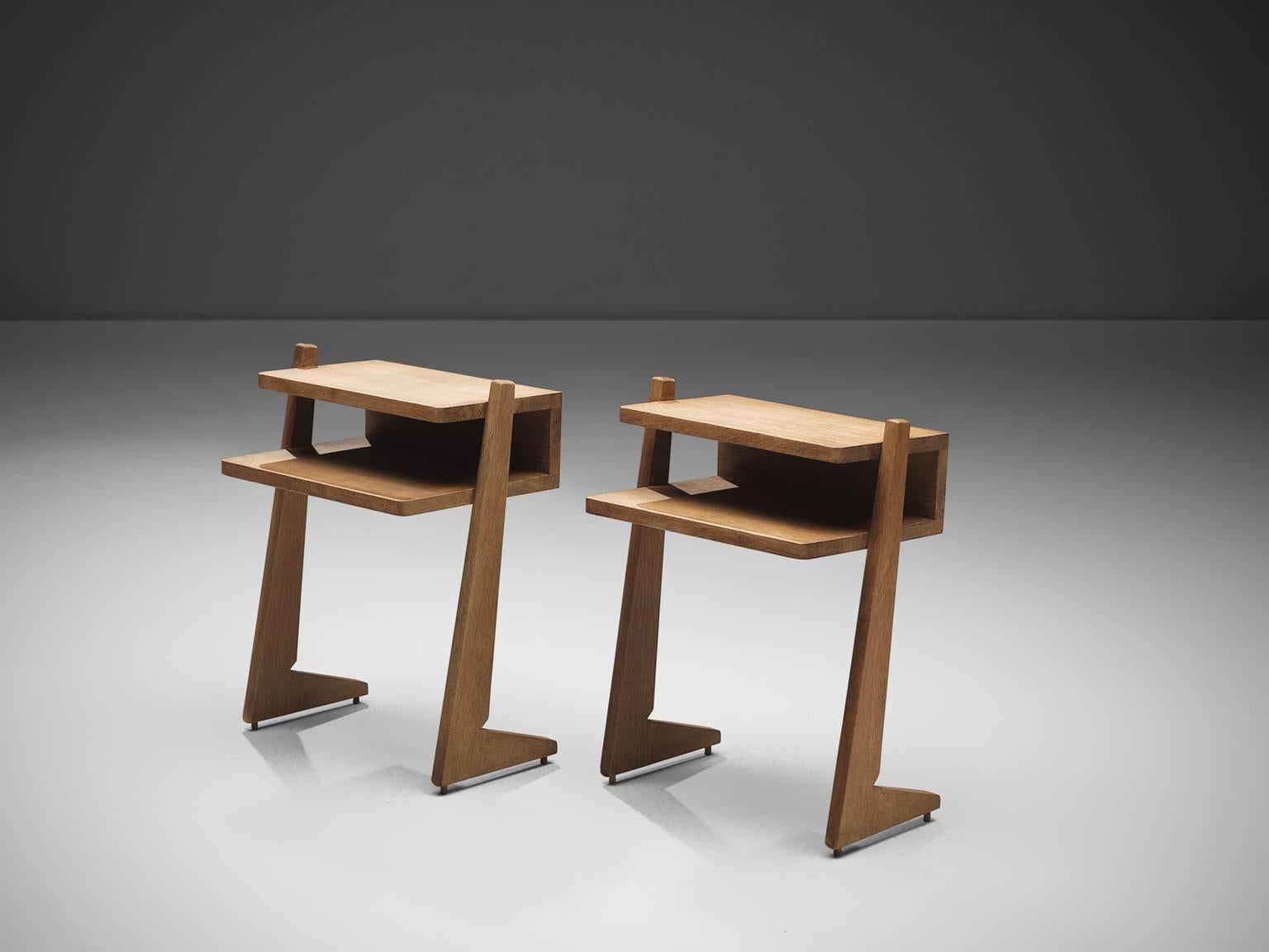 Guillerme & Chambron, nightstands, oak, France, 1960s. 

Nightstands with a geometric shape which uses elements of balance on opposite sides, and a game of proportion. They are pretty corporal but are easy to lift and can be placed easily
