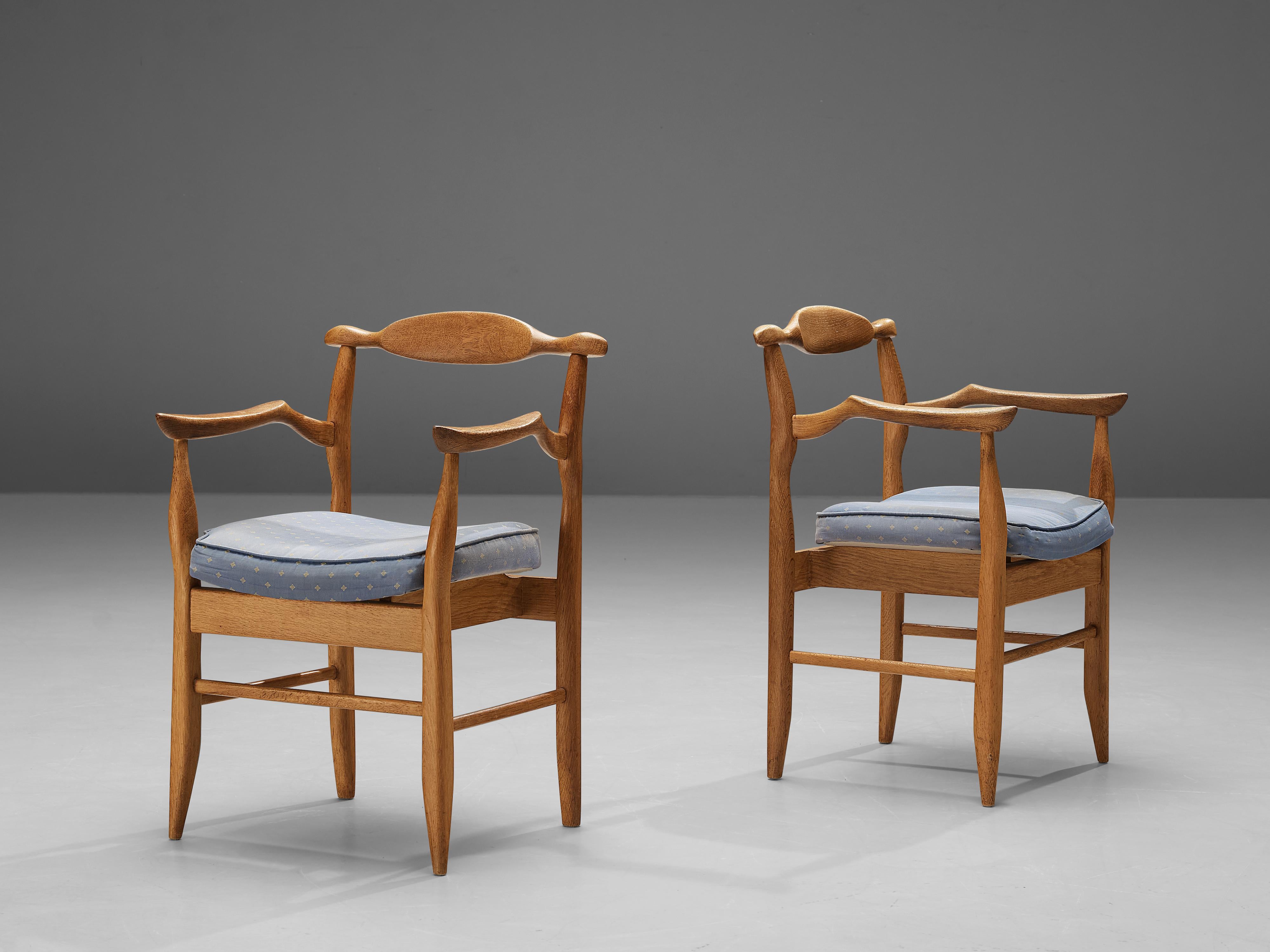 Guillerme & Chambron for Votre Maison, pair of armchairs ‘Fumay’, oak, fabric upholstery, France, 1960s.

Pair of armchairs Guillerme and Chambron. These chairs show the characteristic frame of this French designer duo. Tapered legs and the