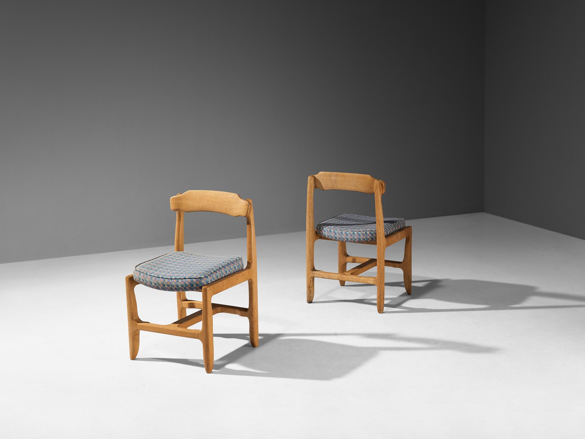 Guillerme et Chambron pair of dining chairs, solid oak, fabric, France, 1960s

These distinctive chairs in beautifully patinated oak are designed by the French duo Jacques Chambron (1914-2001) and Robert Guillerme, (1913-1990). These dining chair