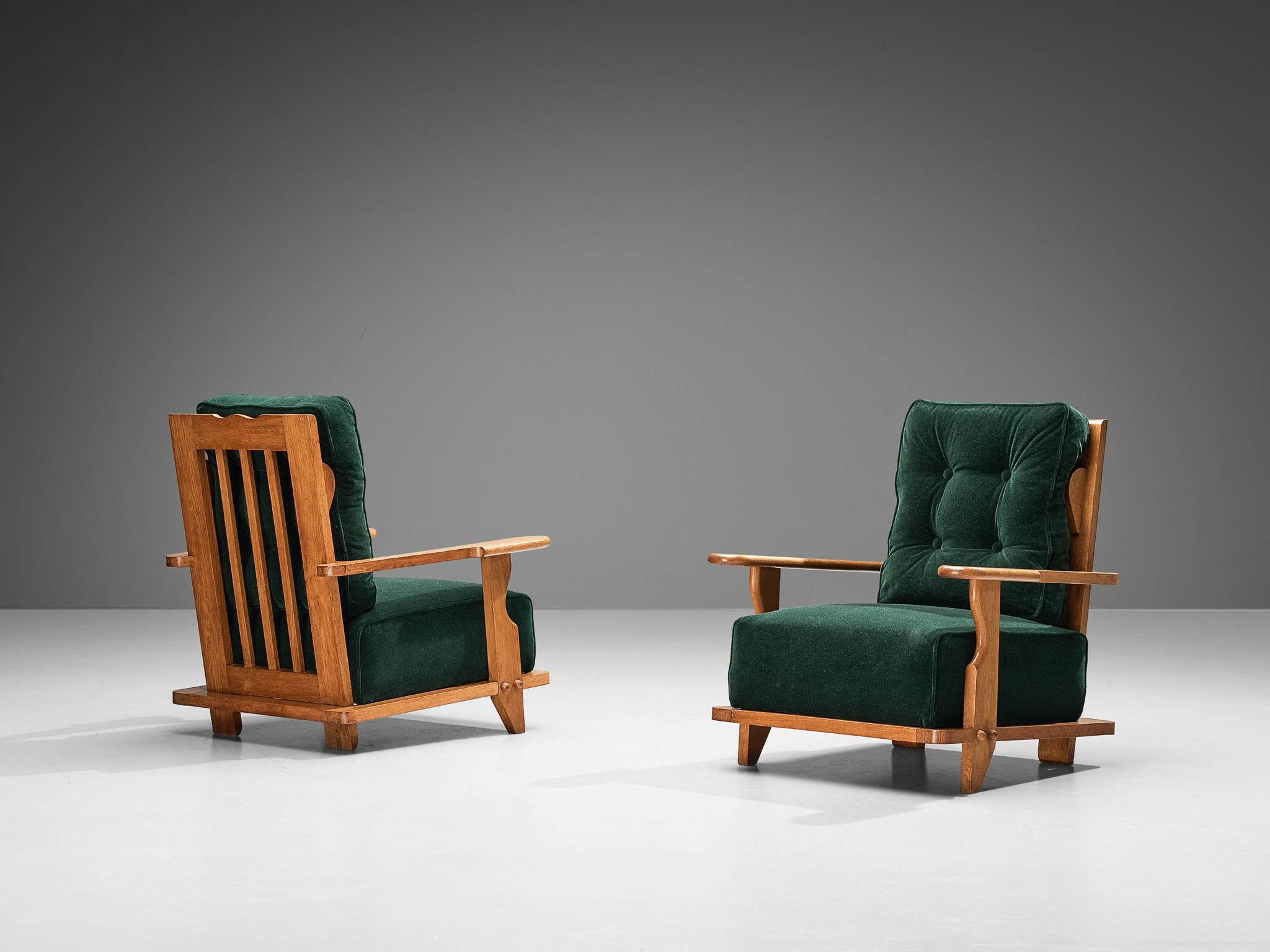 Guillerme & Chambron for Votre Maison, pair of lounge chairs, oak, reupholstered in green mohair, France, 1960s

A great pair of comfortable armchairs with high backs. These chairs have very interesting details. The armrests are pretty broad and