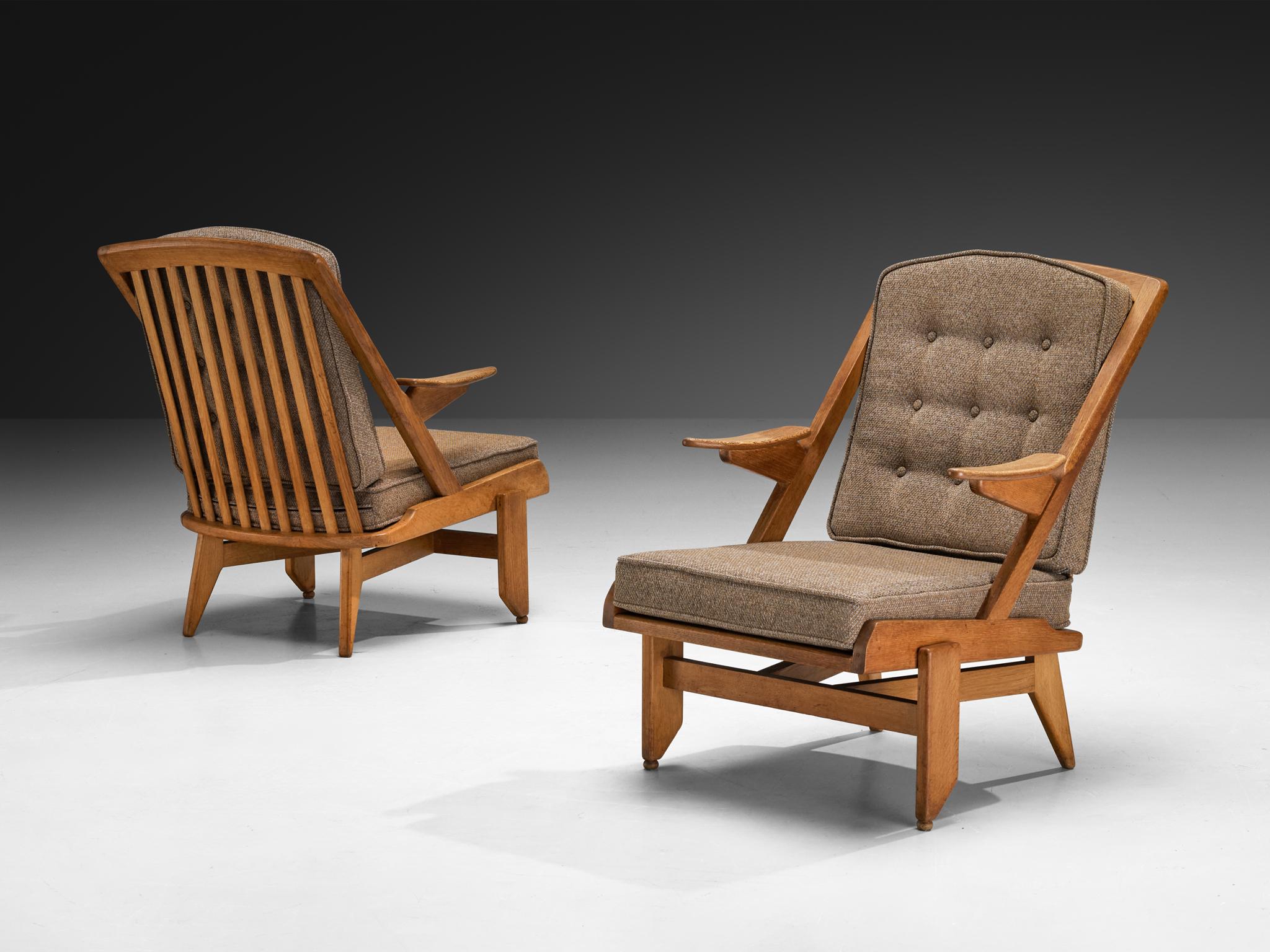 Guillerme & Chambron for Votre Maison, pair of lounge chairs, fabric, oak, France, 1960s

This esteemed French design duo is known for their exceptional craftsmanship in solid oak furniture, exemplified perfectly by this particular set. The chairs