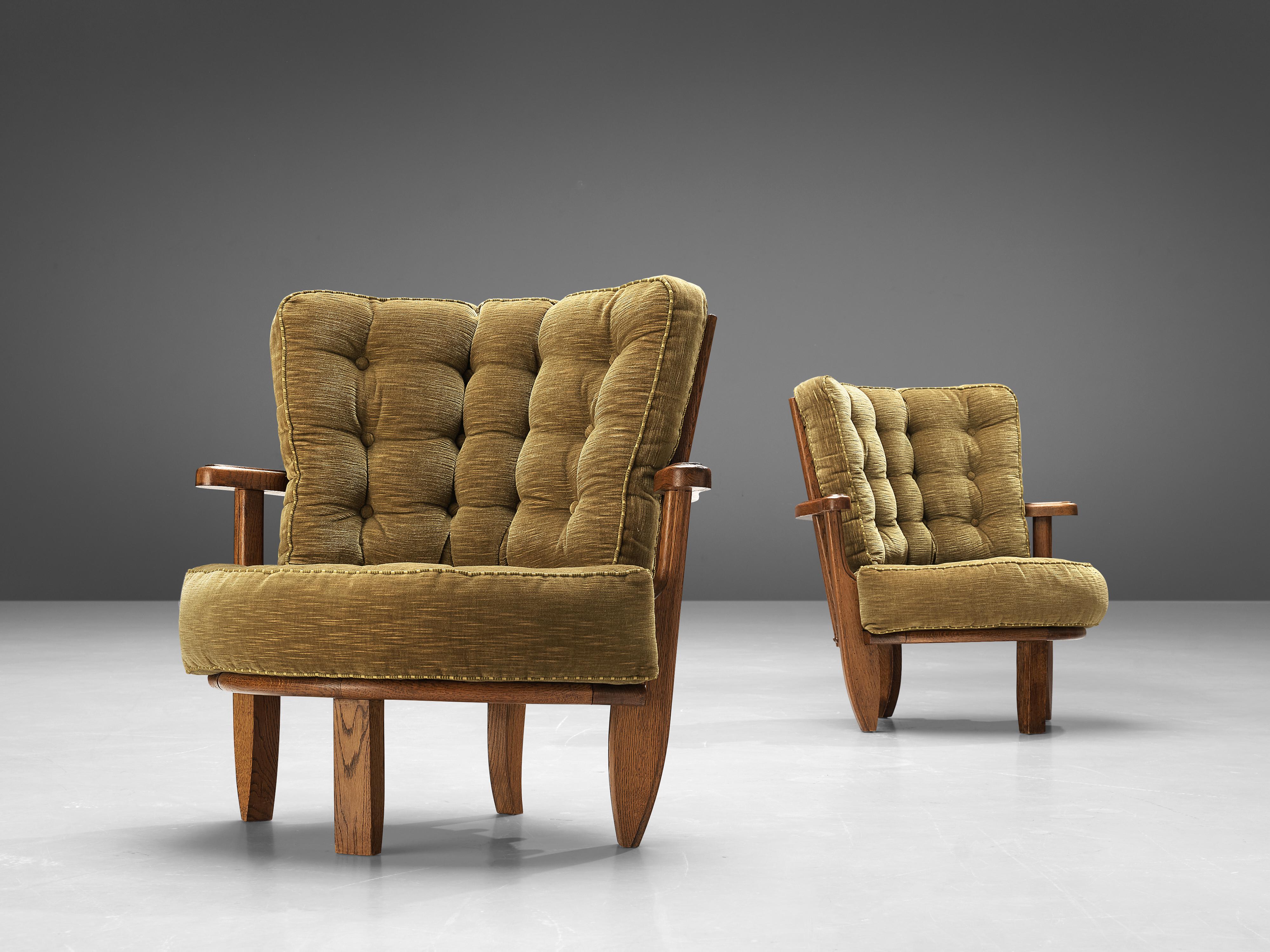Guillerme et Chambron, pair of lounge chairs 'Tricoteuse', oak, fabric upholstery, France, 1960s 

Guillerme et Chambron designed the 'Tricoteuse' lounge chair in solid oak with the typical characteristic decorative details at the back and