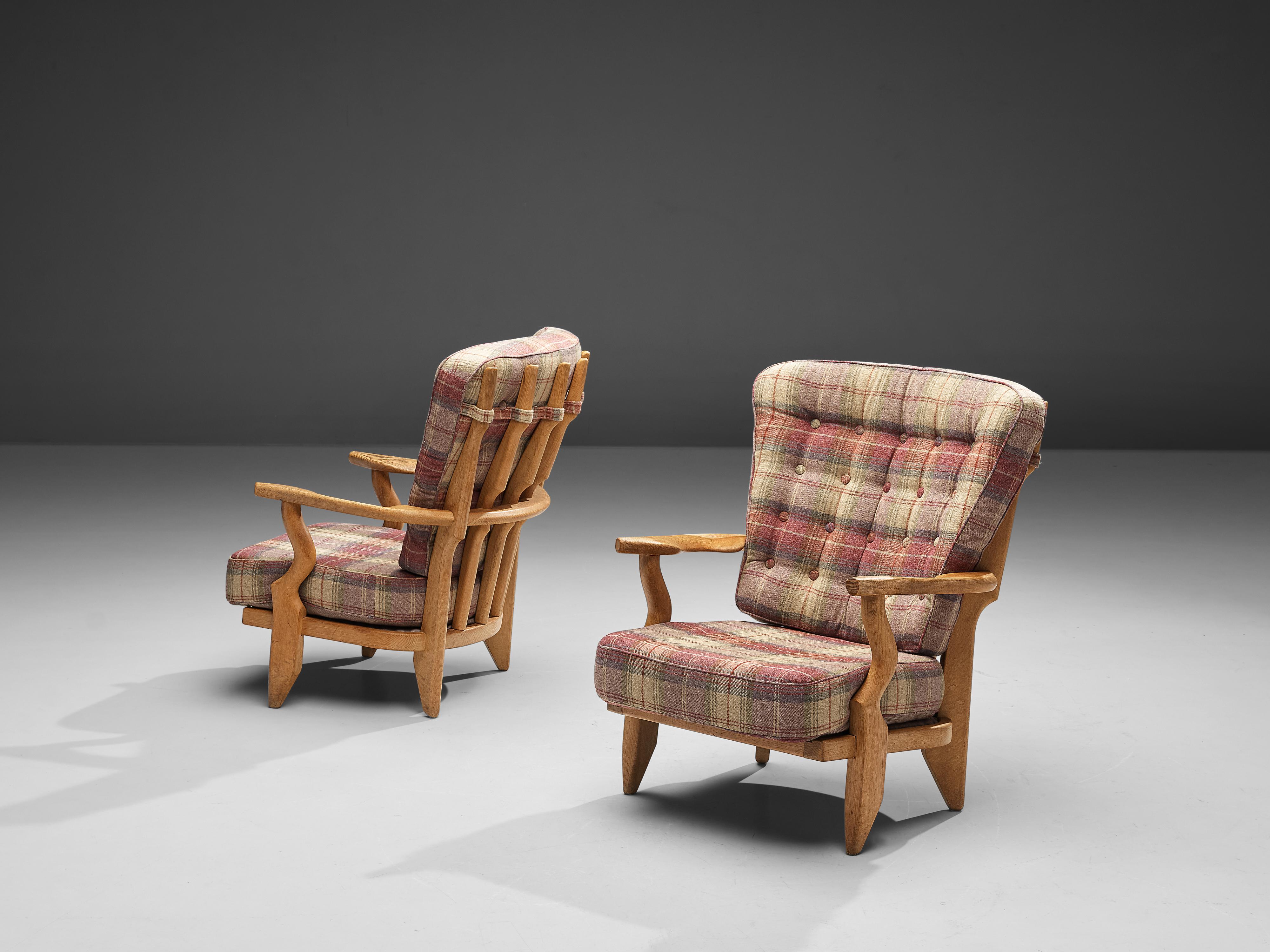 Guillerme & Chambron, pair of 'Mid' Repos lounge chair, oak, upholstery, France, 1960s

Guillerme & Chambron are known for their high quality solid oak furniture, from which these are another great example. The chairs have an interesting,