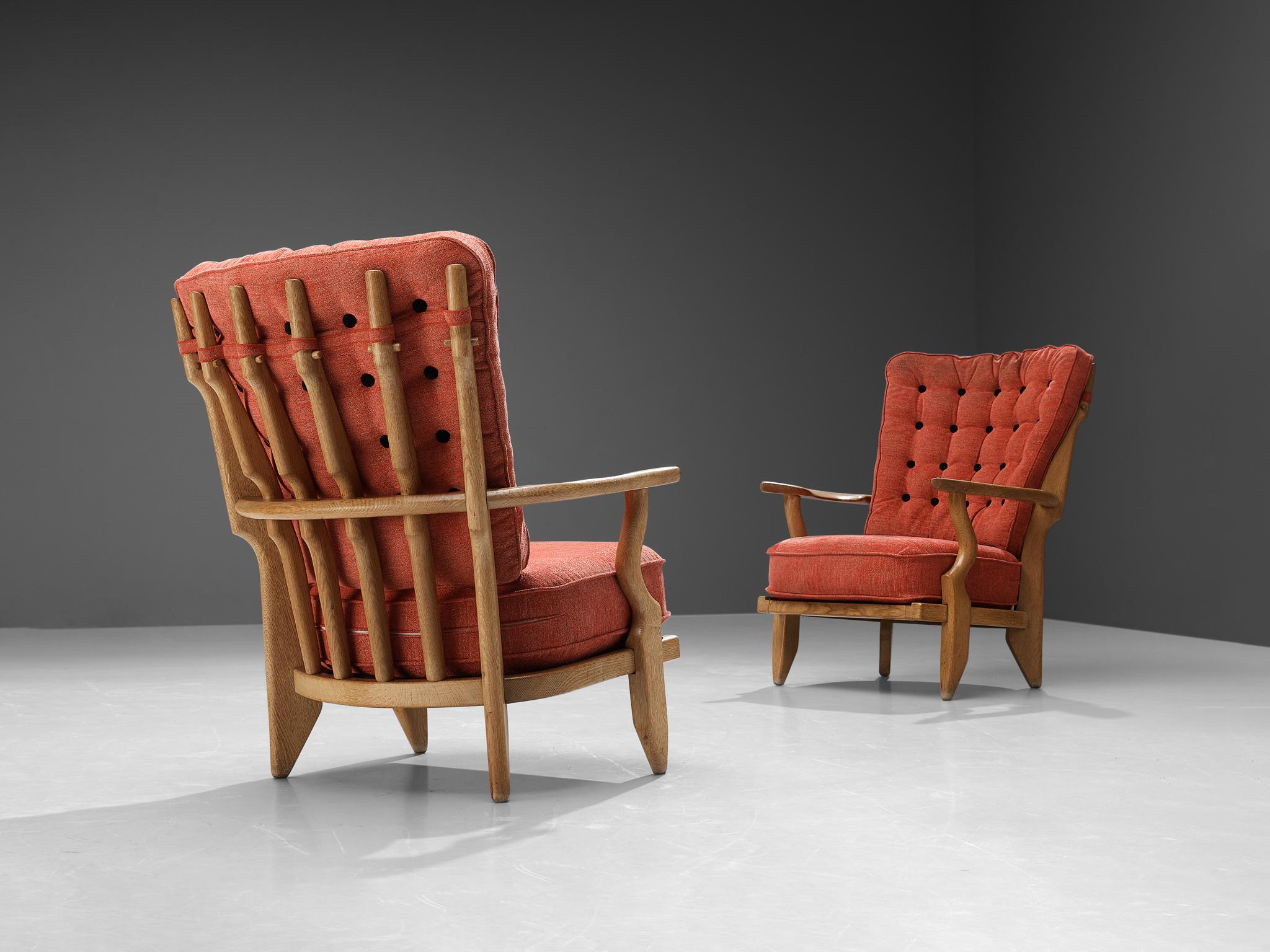 Guillerme et Chambron, lounge chairs, oak, red upholstery, France, 1960s.

Well sculpted Guillerme and Chambron 'Mid Repos' lounge chairs in solid oak with the typical characteristic decorative details at the back and capricious forms of the legs.