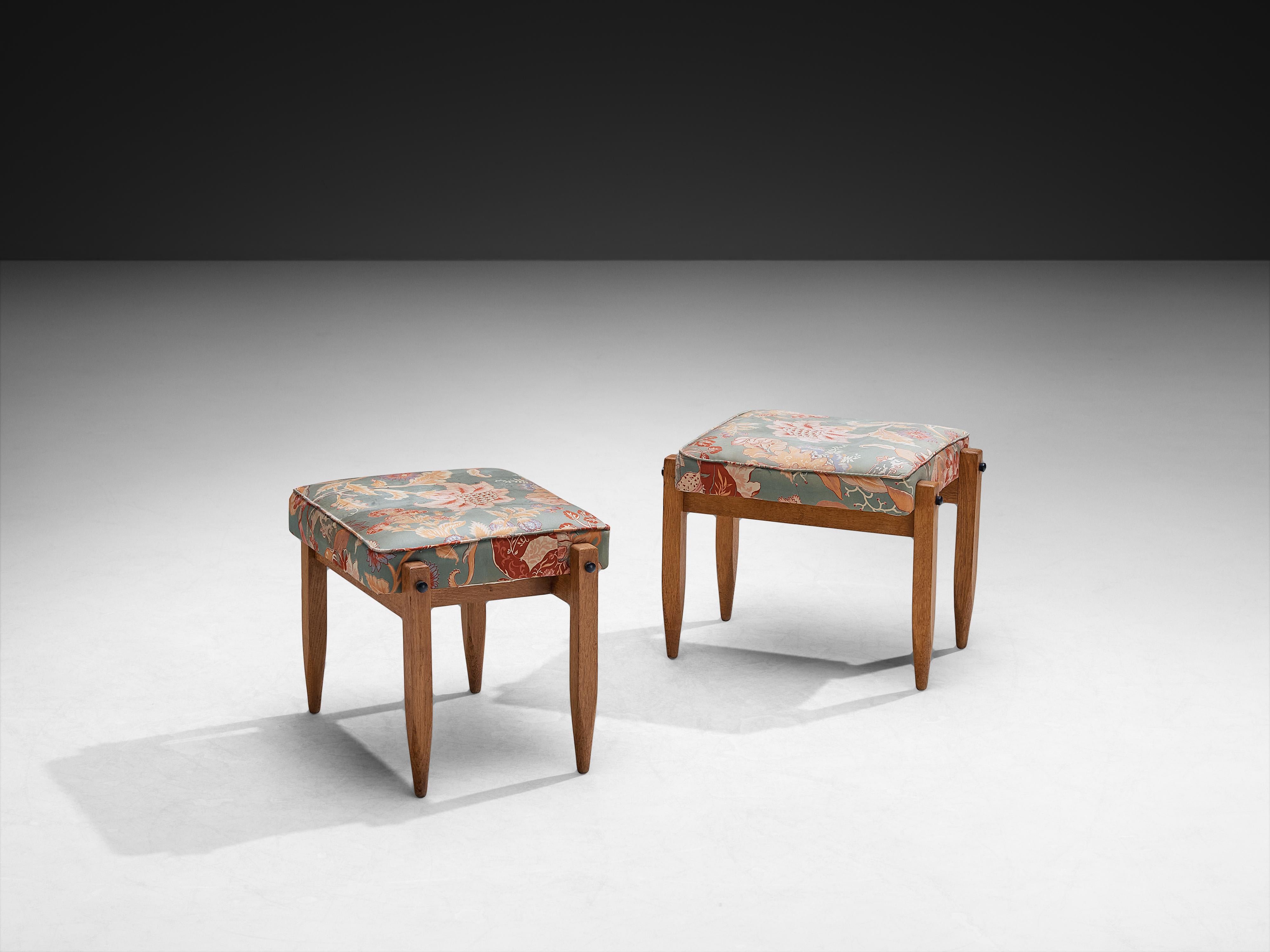 Guillerme 
Chambron for Votre Maison, solid oak, fabric, France, 1950s

This pair of ottomans by Guillerme and Chambron for Votre Maison dates to the 1950s and reflects the duo’s thoughtful approach to form and material. Crafted in oak, the