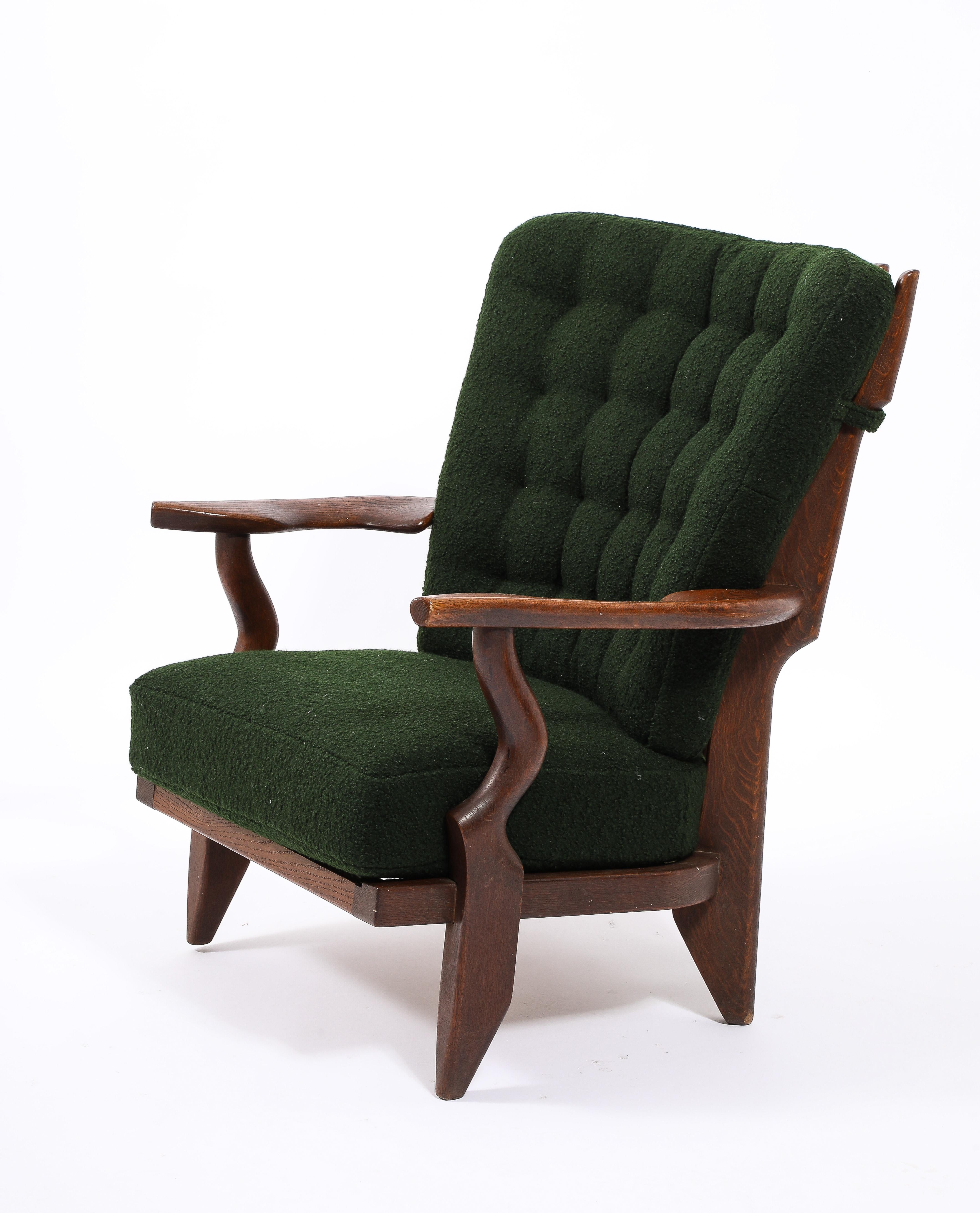 An early example of the petit repos chair in original patina, newly upholstered in a green bouclé.
