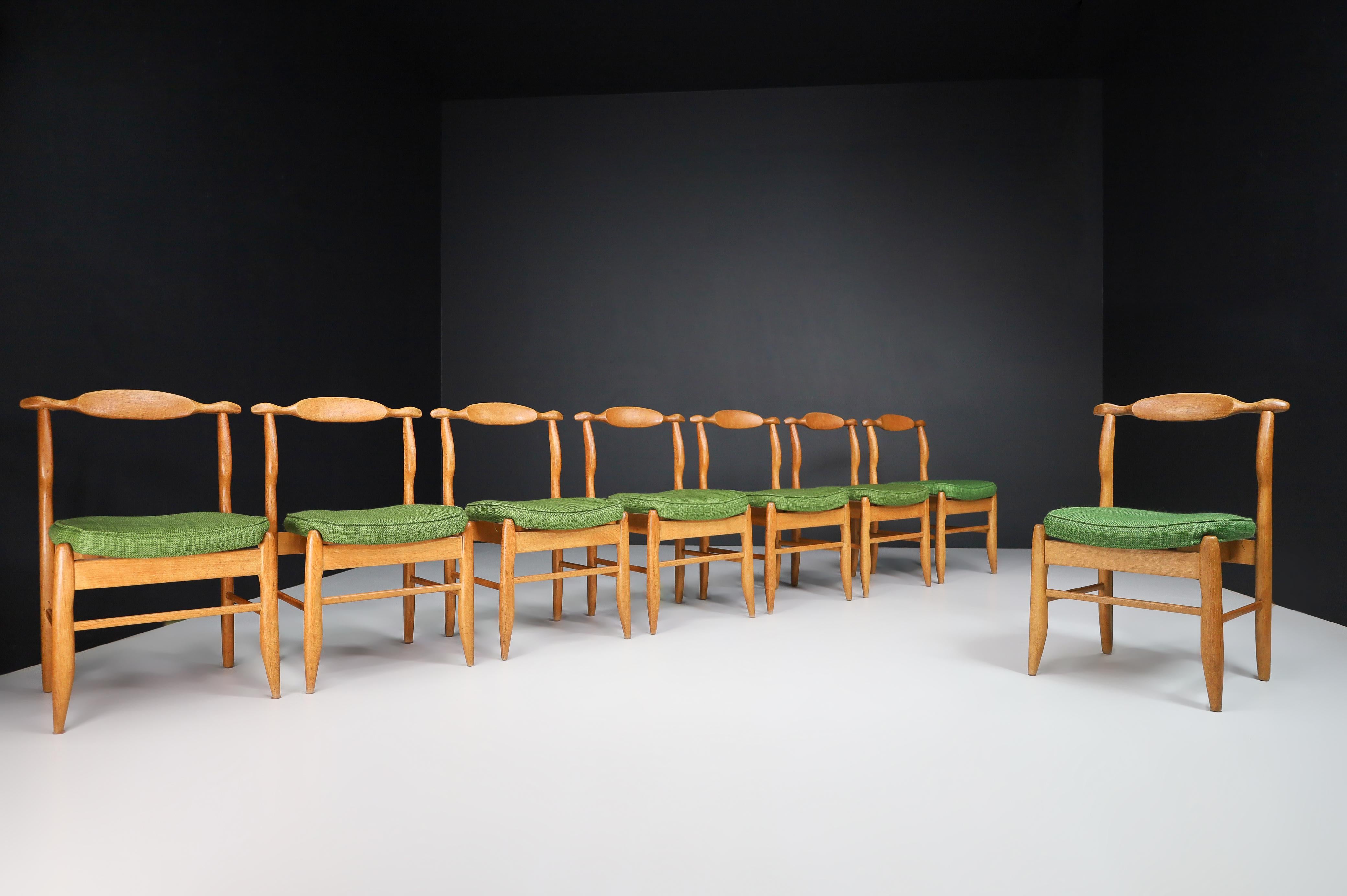 Guillerme & Chambron Set of Eight dining chairs in Oak and Forrest Green Fabric, France 1960s

Guillerme et Chambron, set of eight dining chairs model 'Fumay,' oak, original forest green fabric, France, 1960s. Beautifully shaped chairs in
