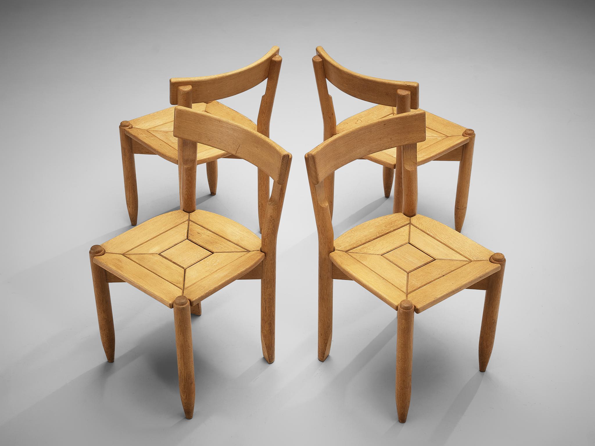 Guillerme & Chambron for Votre Maison, set of four dining chairs model ‘Trèfle’, solid oak, France, 1960s

The ‘Trèfle’ (French for clover) dining chairs by Guillerme & Chambron feature a decorative seat. A square in the center is flanked by two