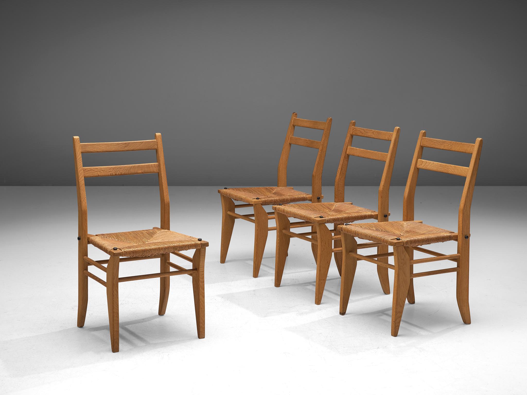 Guillerme & Chambron, set of four dining chairs, oak and rope, France, 1960s.

Set of four dining chairs in solid oak by Guillerme and Chambron. These chairs show a modest backrest that is combined with the characteristic sculpted legs of the French