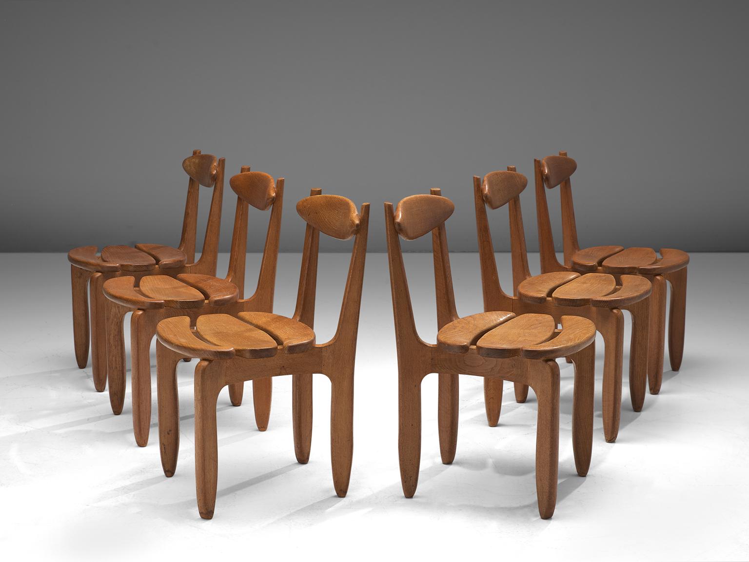 Guillerme et Chambron, set of 6 dining chairs, in oak, France, 1960s. 

Set of 6 elegant and robust dining chairs in solid oak by Guillerme and Chambron. These chairs show the characteristic frame of this French designer duo, well-crafted, solid