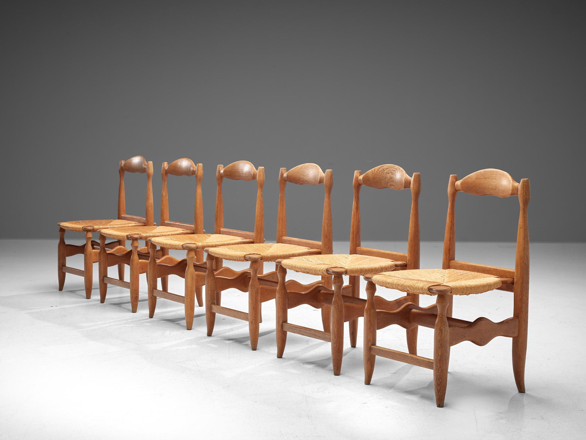 Guillerme & Chambron for Votre Maison, set of six dining chairs, oak, cane, France, 1960s

Set of six elegant dining chairs in solid oak by Guillerme and Chambron. These chairs show the characteristic frame of this French designer duo. Tapered