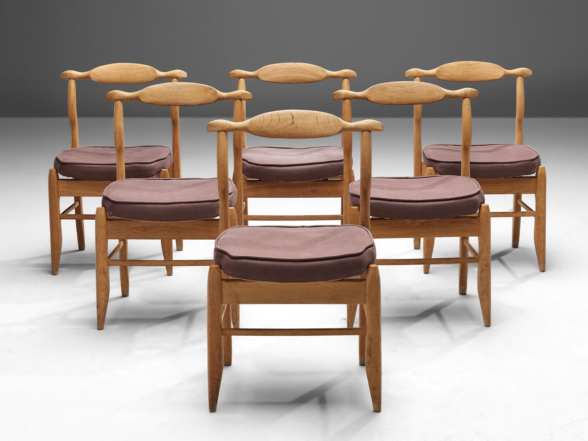 Guillerme & Chambron, set of six dining chairs model 'Fumay,' oak and fabric, France, 1960s.

Beautifully shaped chairs in patinated oak by French designer duo Jacques Chambron and Robert Guillerme. These dining chairs show beautiful lines in
