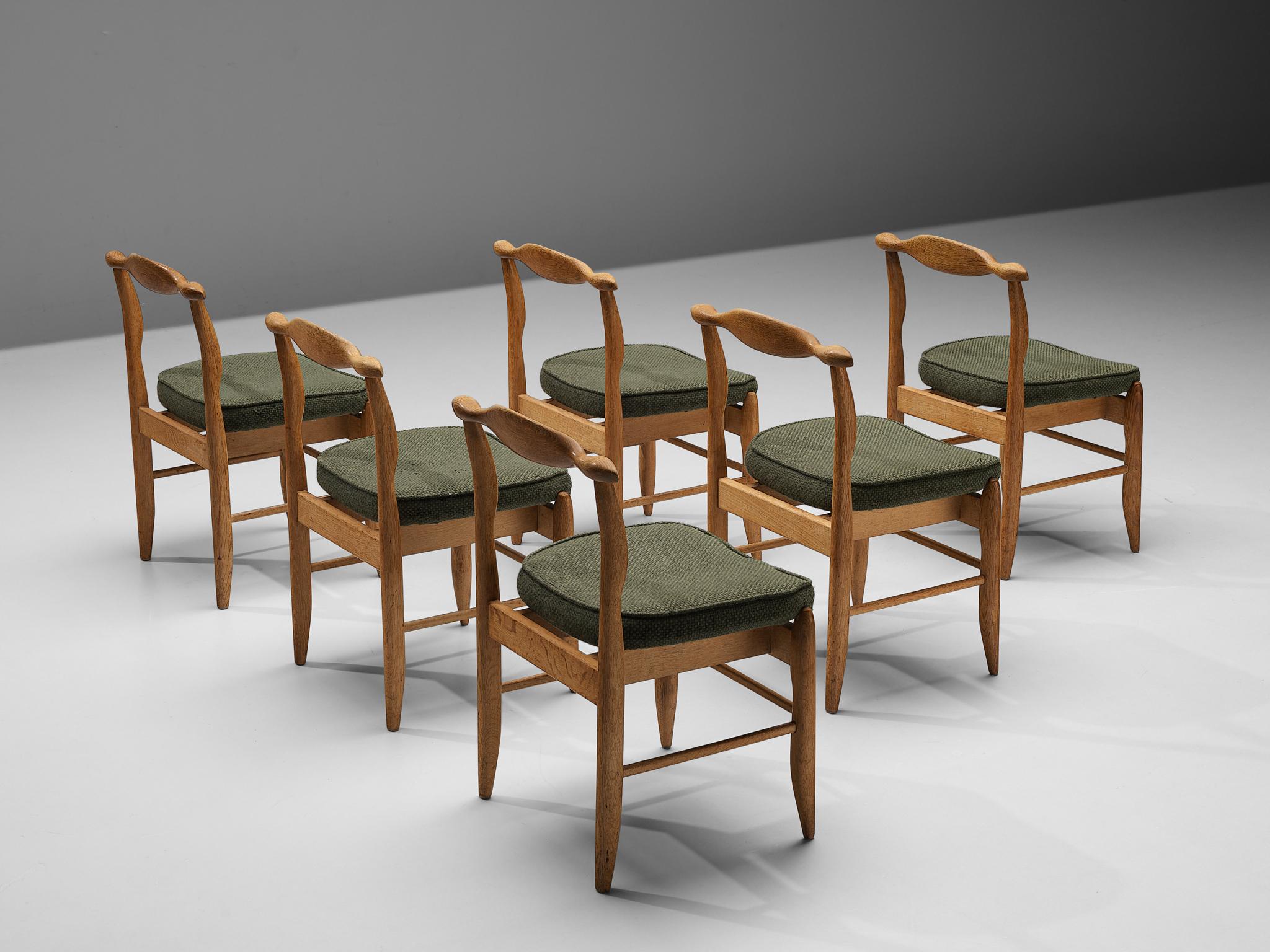 Guillerme et Chambron for Votre Maison, set of six dining chairs, model 'Fumay,' oak and fabric, France, 1960s.

Beautifully shaped chairs in oak by French designer duo Jacques Chambron and Robert Guillerme. These dining chairs show beautiful lines