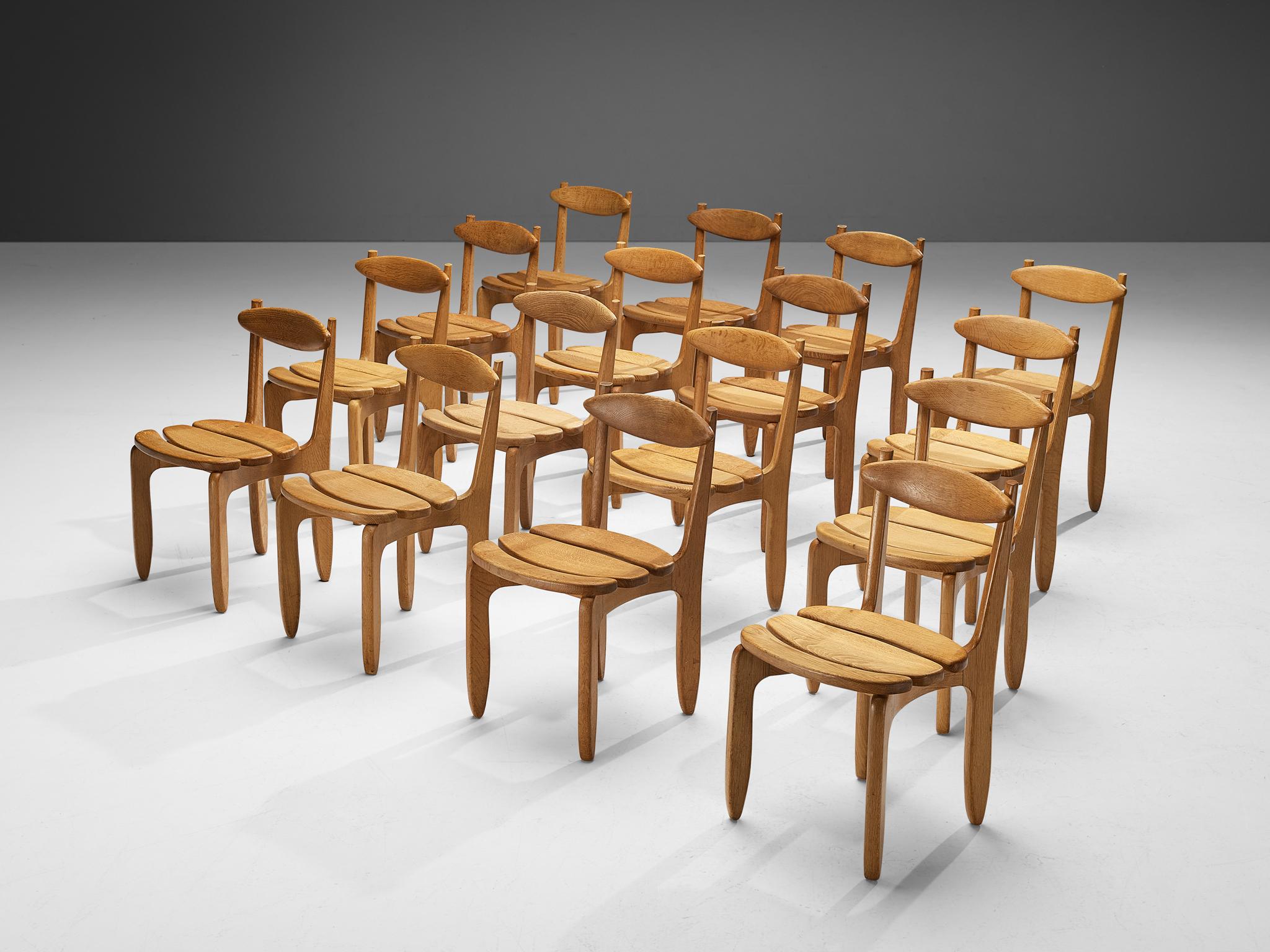 Guillerme et Chambron for Votre Maison, set of sixteen dining chairs, oak, France, 1960s.

Set of sixteen elegant and robust dining chairs in solid oak by Guillerme and Chambron. These chairs show the characteristic frame of this French designer