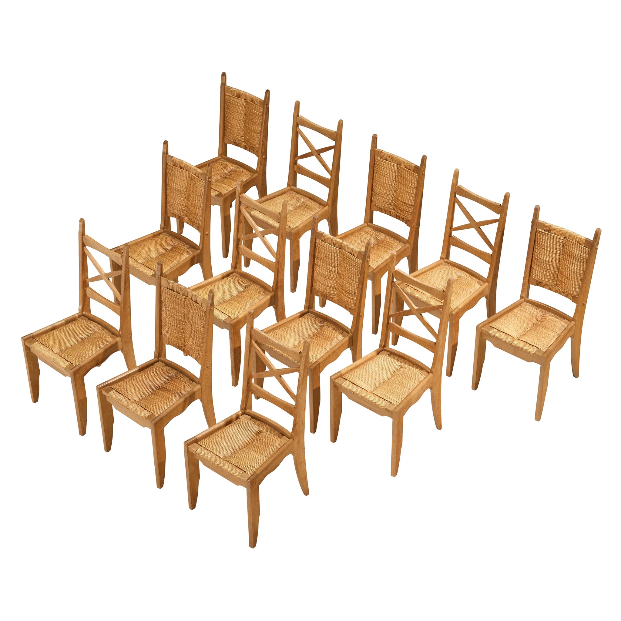 Guillerme & Chambron Set of Twelve Dining Chairs in Oak and Straw For Sale