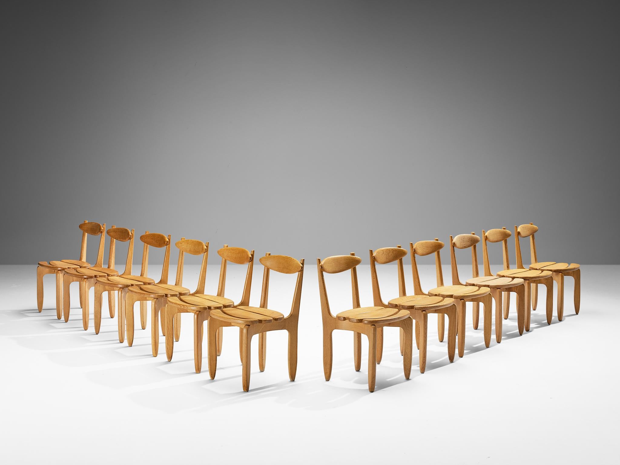 Guillerme et Chambron for Votre Maison, set of twelve dining chairs, oak, France, 1960s.

Set of twelve elegant and robust dining chairs in solid oak by Guillerme and Chambron. These chairs show the characteristic frame of this French designer duo,