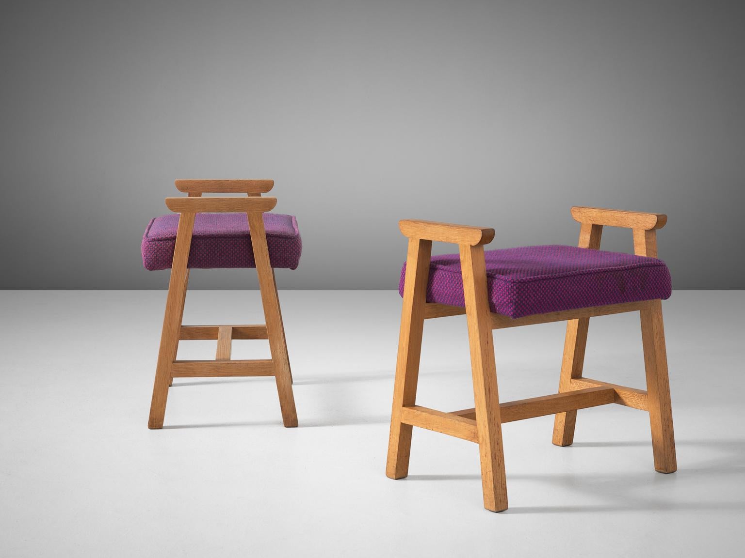 Guillerme et Chambron, set of two stools, oak and purple fabric, France, 1960s. 

This duo of solid oak wooden stools with the muted yellow colors are designed by the French designer duo Guillerme and Chambron. These stools have a frame in oak with