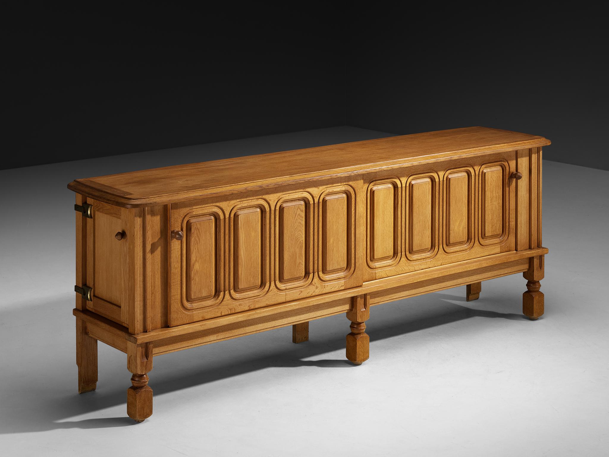 Guillerme et Chambron for Votre Maison, sideboard, oak, France, 1960s.

This charming sideboard is made by the designer duo Guillerme & Chambron. This particular design is characterized by a solid construction with beautiful carved lines and
