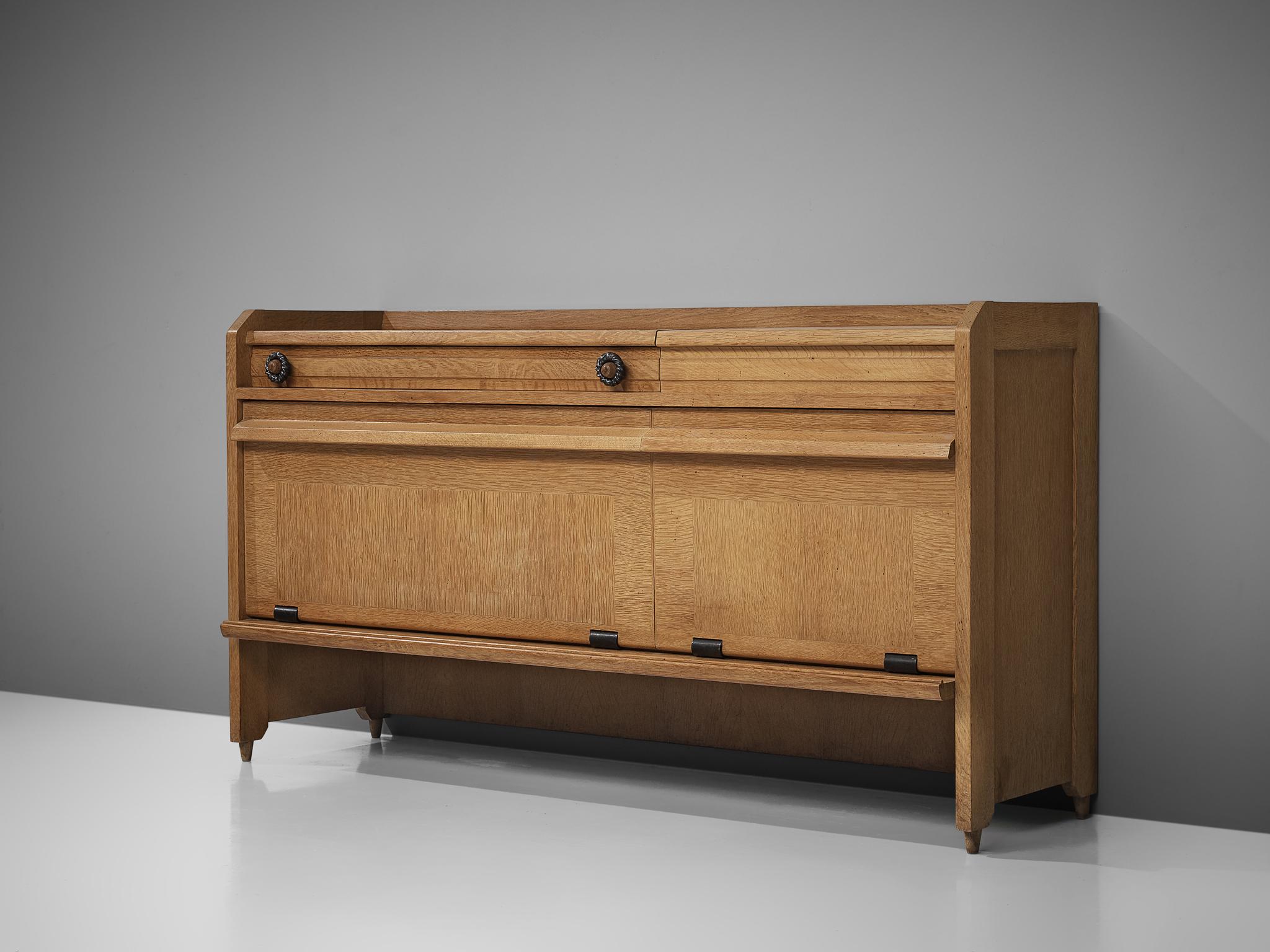 Credenza, in oak and ceramic, by Robert Guillerme et Jacques Chambron for Votre Maison, France, 1960s.

Cabinet by French designer duo Guillerme and Chambron. Characterized by the oak wood inlay patterns and ceramic decorations. The high and