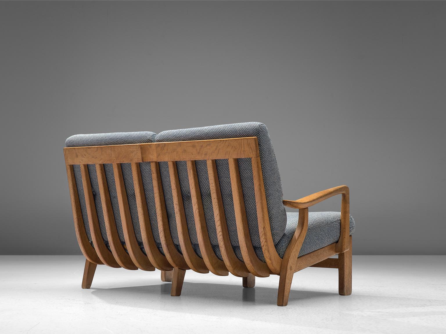 Guillerme & Chambron, sofa, oak, fabric, France, 1960s. 

Beautiful two-seat settee by Guillerme & Chambron, in solid oak. The back of the seat has been beautifully finished with wooden slats which adds an original and interesting character to the