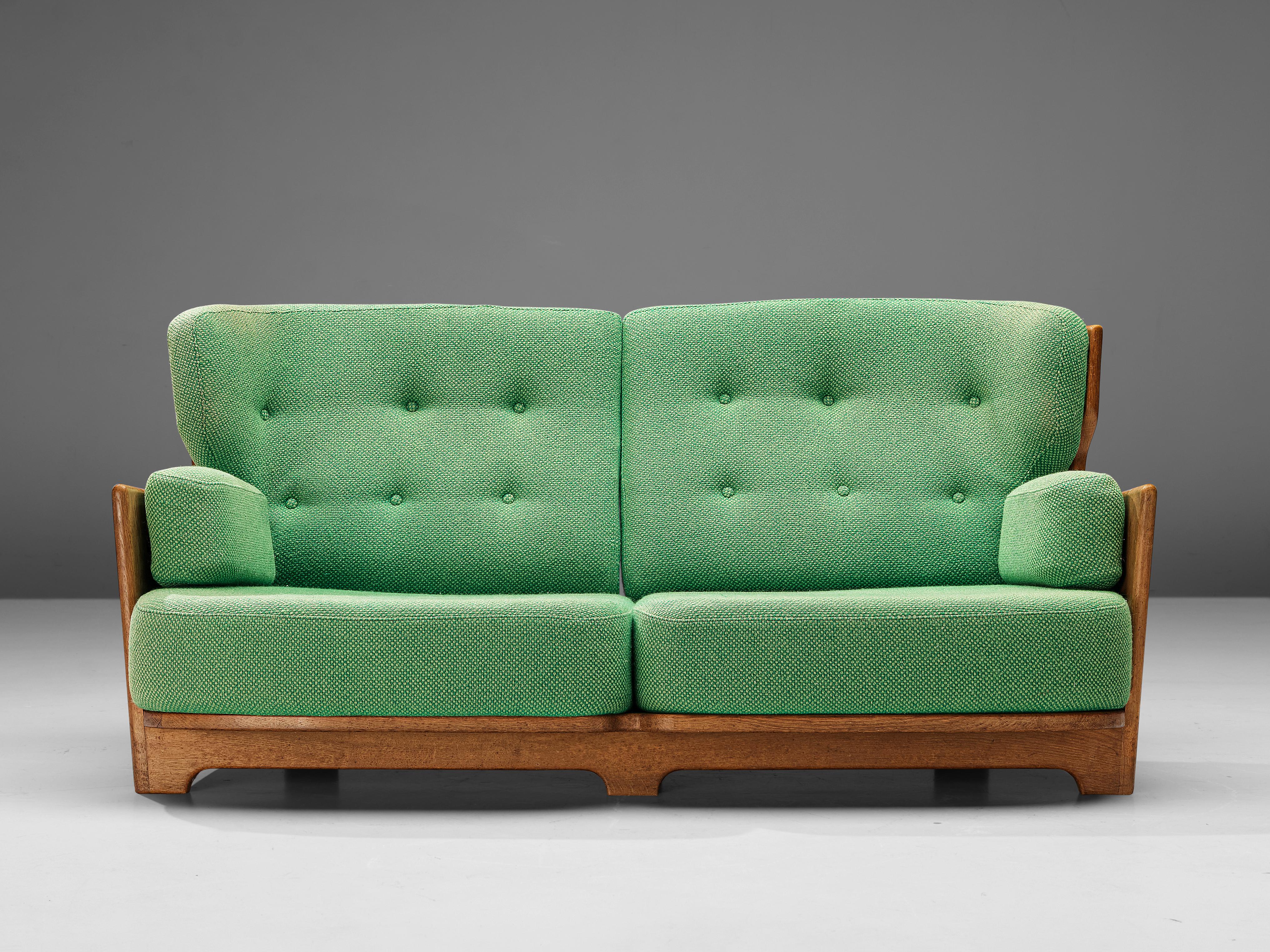 Guillerme & Chambron for Votre Maison, sofa, model 'Denis', fabric, oak, France, 1960s

Extraordinary Guillerme and Chambron sofa in solid oak with the typical characteristic decorative details at the back and capricious forms of the legs. This