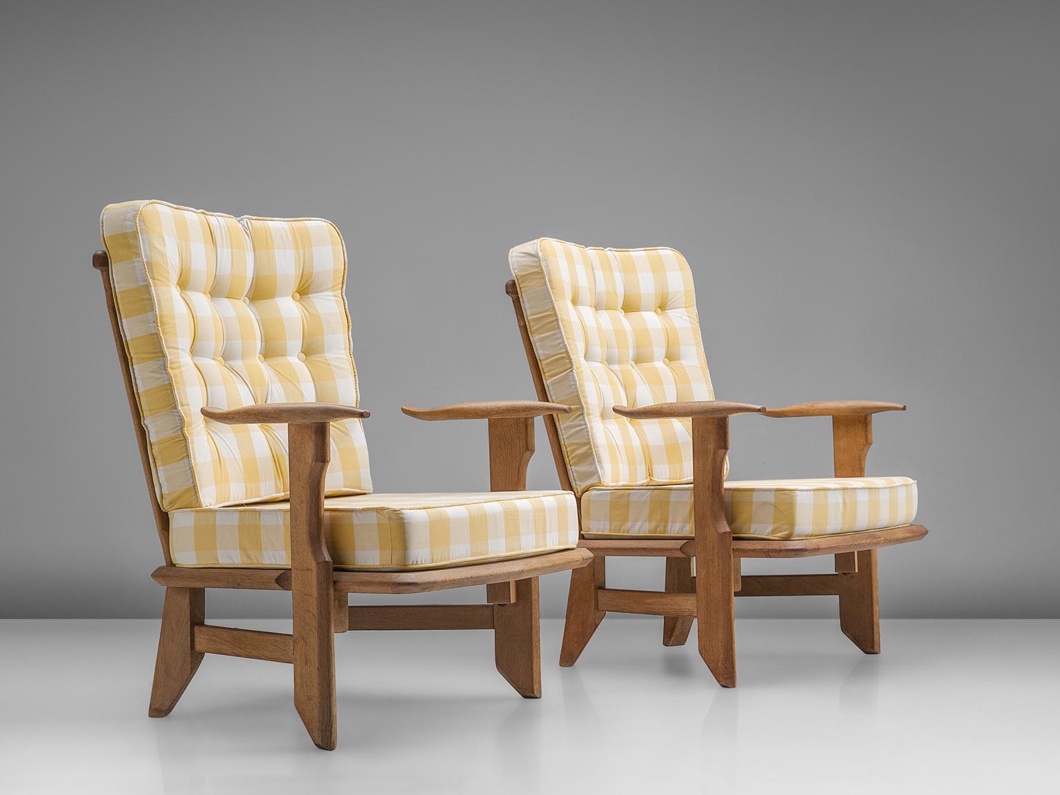 Lounge chairs oak, with a checked white and yellow colored upholstery by Guillerme et Chambron, France, 1960s. 

Guillerme and Chambron are known for their high quality solid oak furniture, from which this is another great example. These chairs has