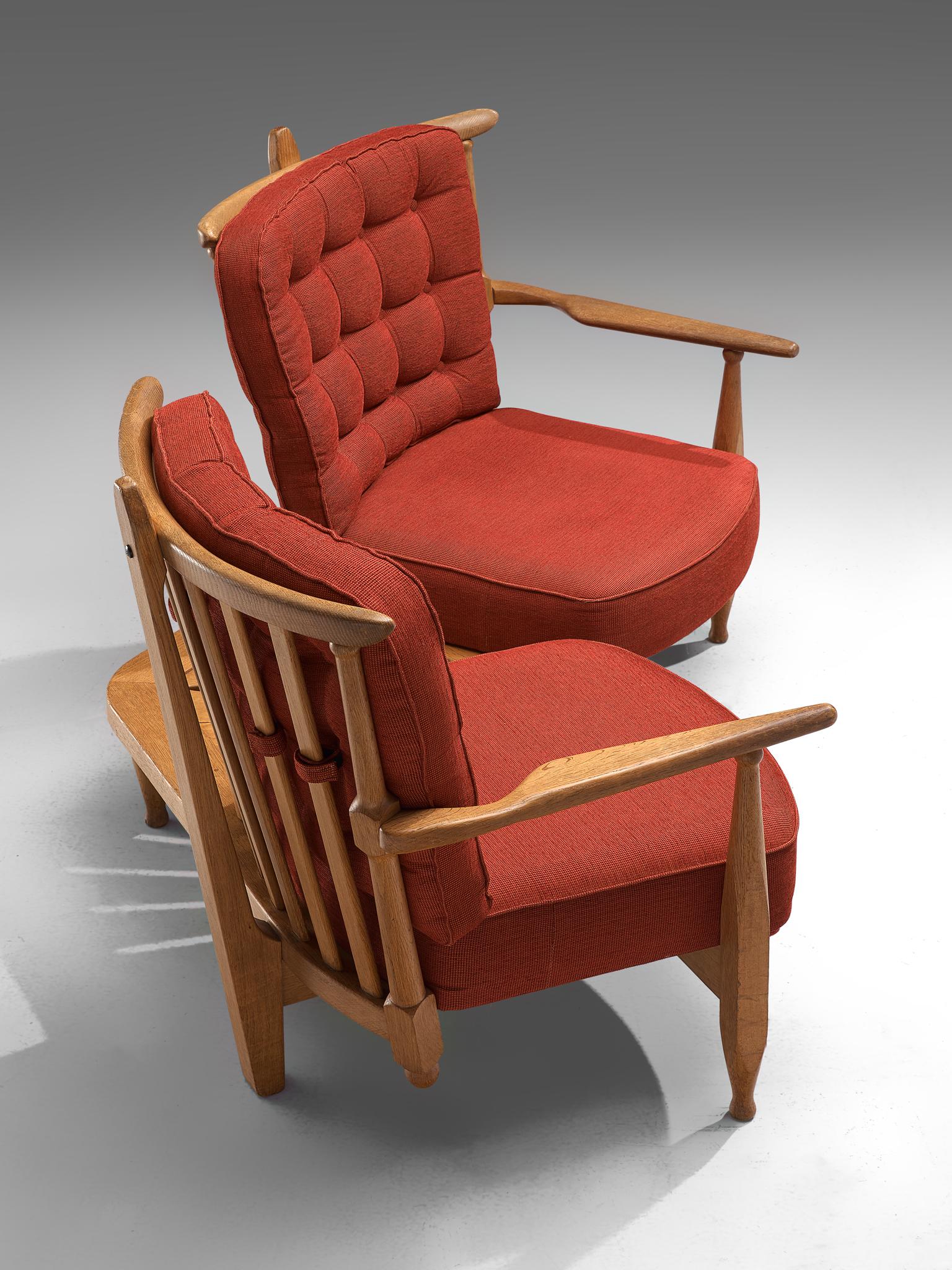 Guillerme et Chambron for Votre Maison, lounge chairs in oak, red upholstery, France, 1940s.

Guillerme and Chambron are known for their high quality solid oak furniture, from which this piece is another great example. The curved slatted back is an