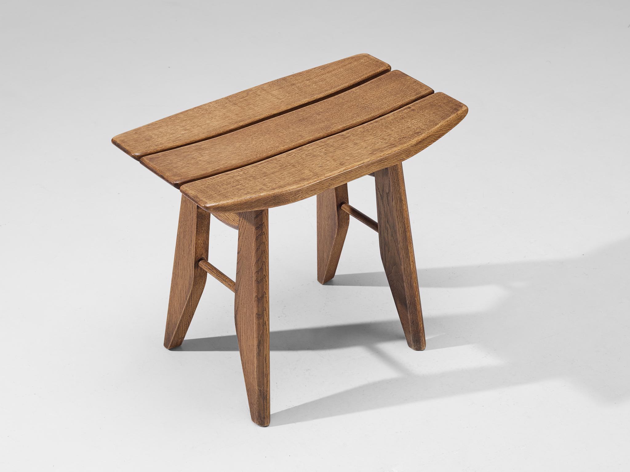 Guillerme et Chambron for Votre Maison, stool, solid oak, France, 1960s.

This oak tabouret, designed by the French duo Guillerme and Chambron, boasts a sculptural form with distinct Japanese influences. The seat is composed of three slats, with