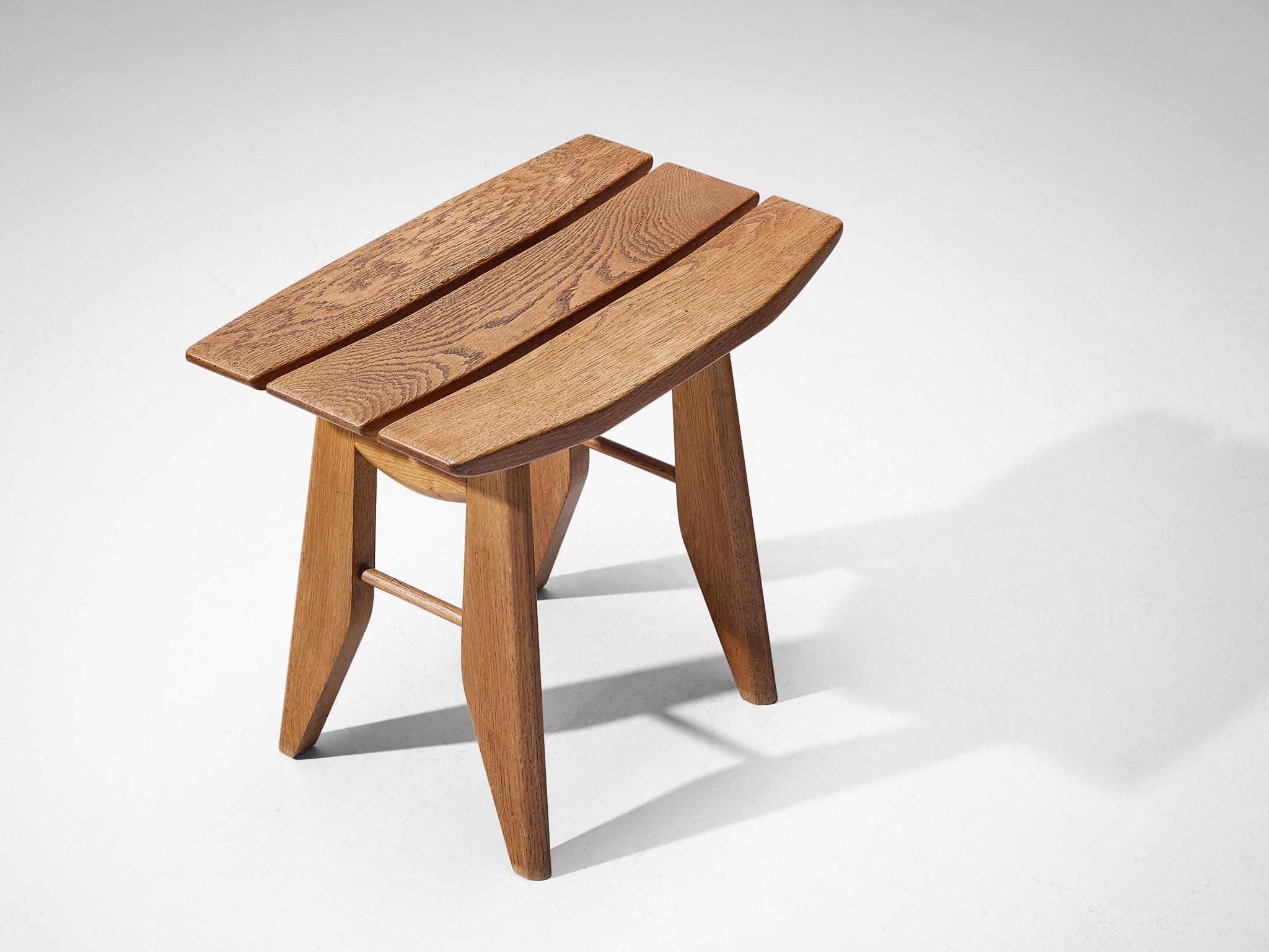 Guillerme et Chambron for Votre Maison, stool, solid oak, France, 1960s.

This oak tabouret, designed by the French duo Guillerme and Chambron, boasts a sculptural form with distinct Japanese influences. The seat is composed of three slats, with