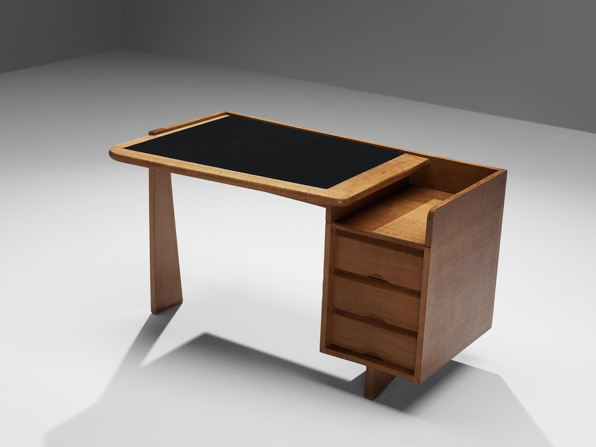 Guillerme et Chambron for Votre Maison, writing desk, oak, leather, France, 1960s.

This desk is designed by the renowned French duo Guillerme et Chambron. This item holds an utterly well-balanced construction supported by the characteristic