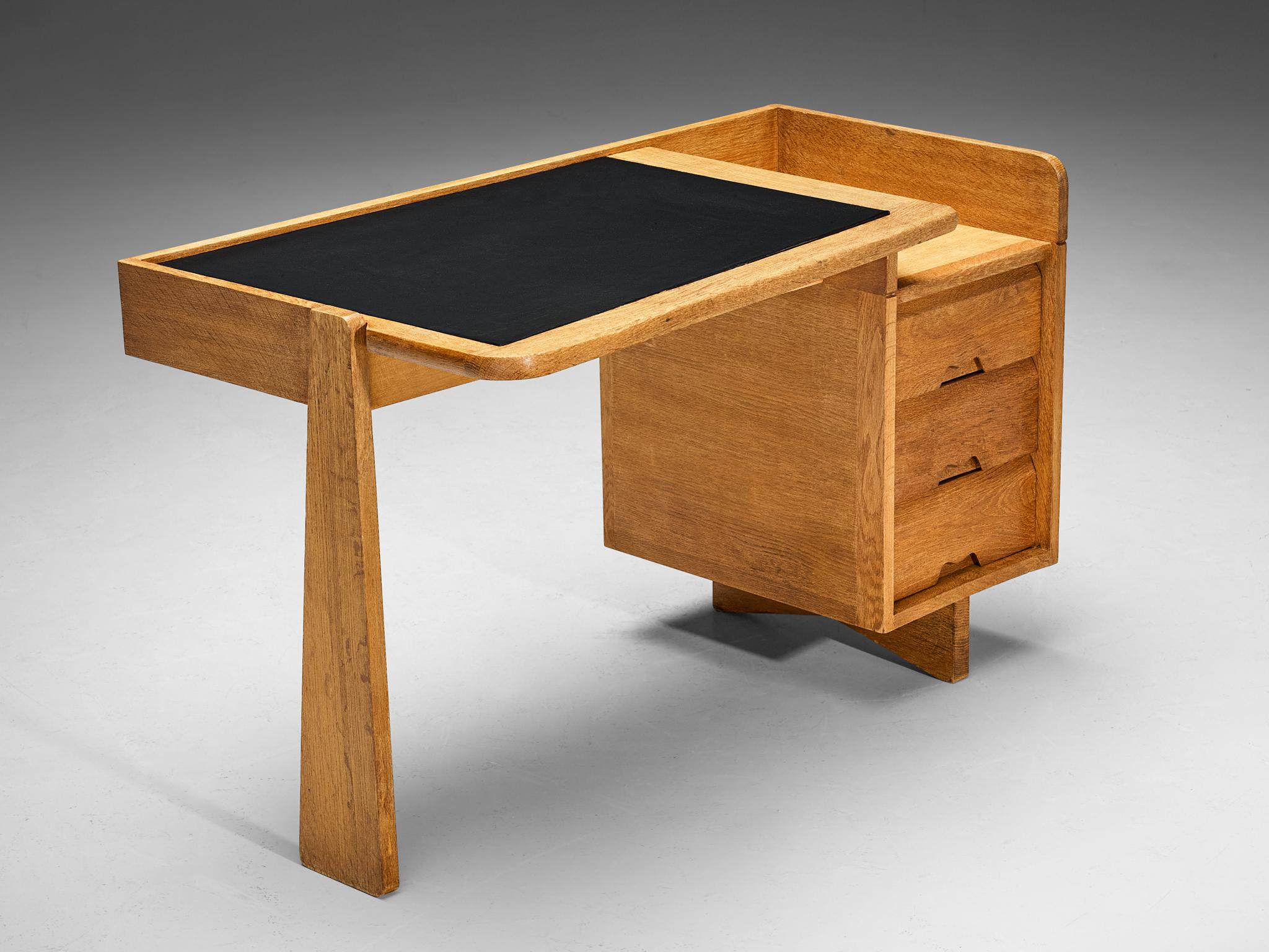 Guillerme et Chambron for Votre Maison, writing desk, oak, leather, France, 1960s.

This desk is designed by the renowned French duo Guillerme et Chambron. This design holds an utterly well-balanced construction supported by the characteristic
