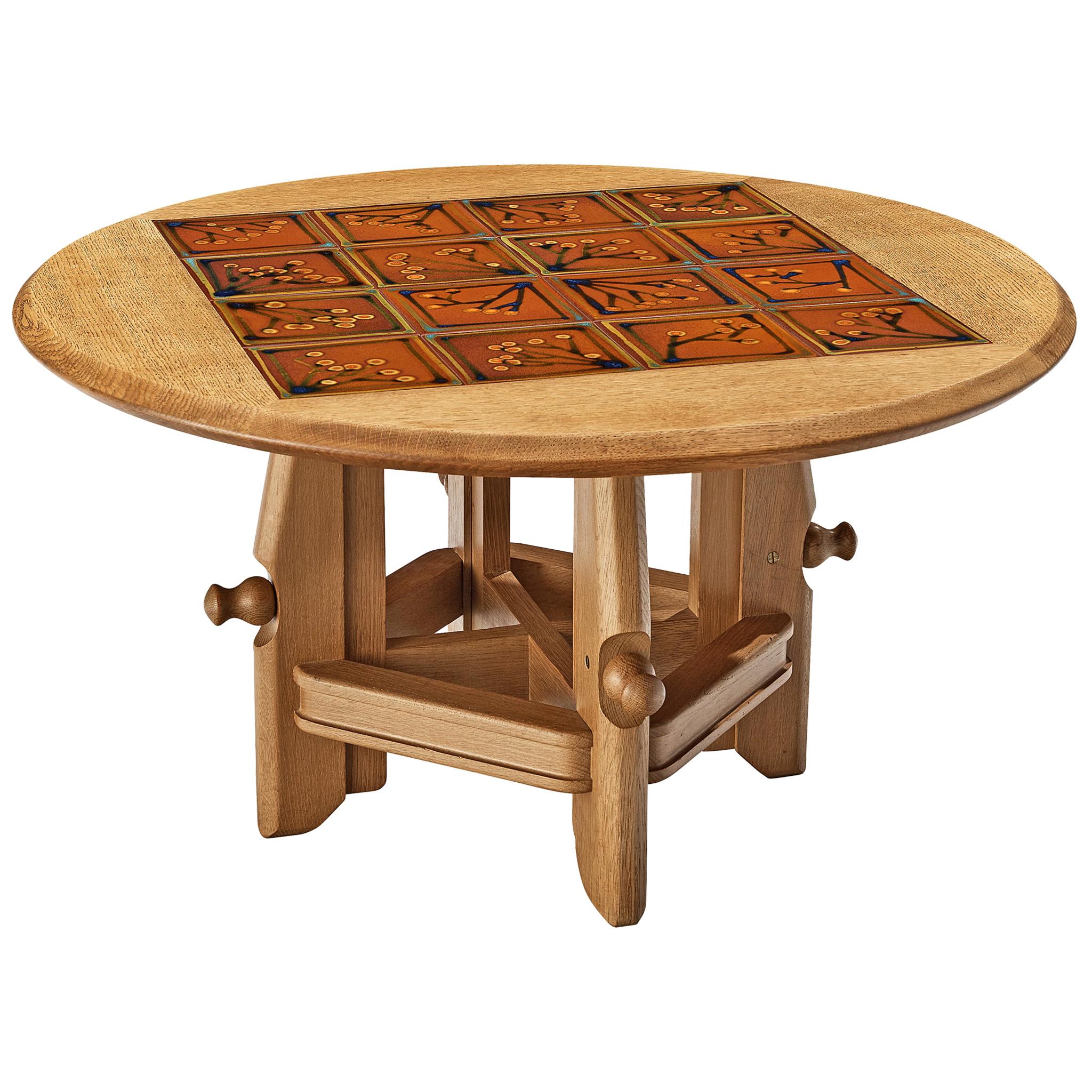 Guillerme et Chambron for Votre Maison, coffee table, oak, ceramic, France, 1960s

Adjustable coffee table with low and high position. The top is adorned with inlaid ceramic tiles in vibrant brown toned colours and floral motifs. The oak frame shows