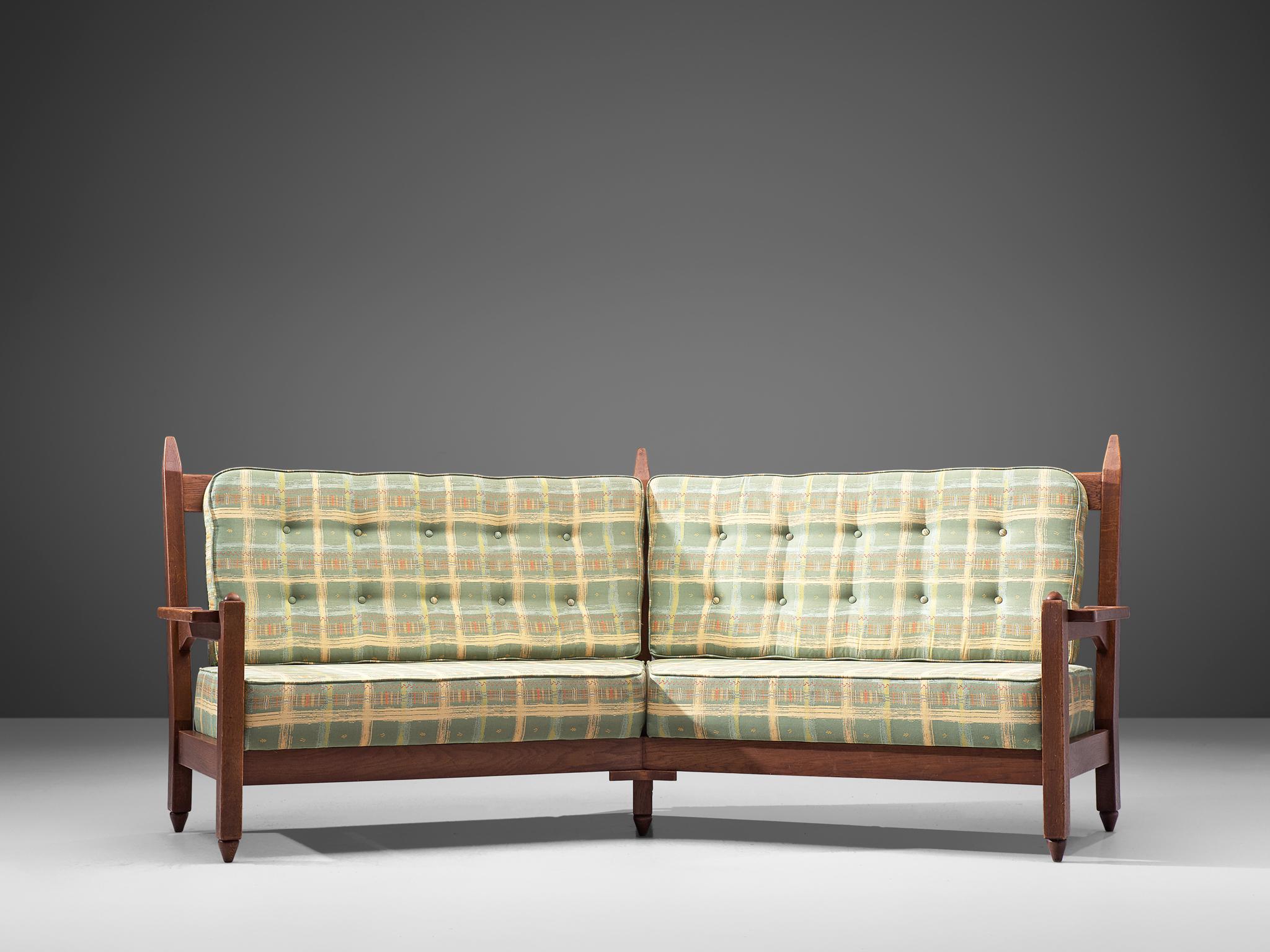 Guillerme et Chambron for Votre Maison, curved sofa, solid oak and fabric, France, 1960s.

This sculptural carved oak sofa is designed by Guillerme and Chambron. The design duo is known for their sculptural, crafted solid oak furniture. This