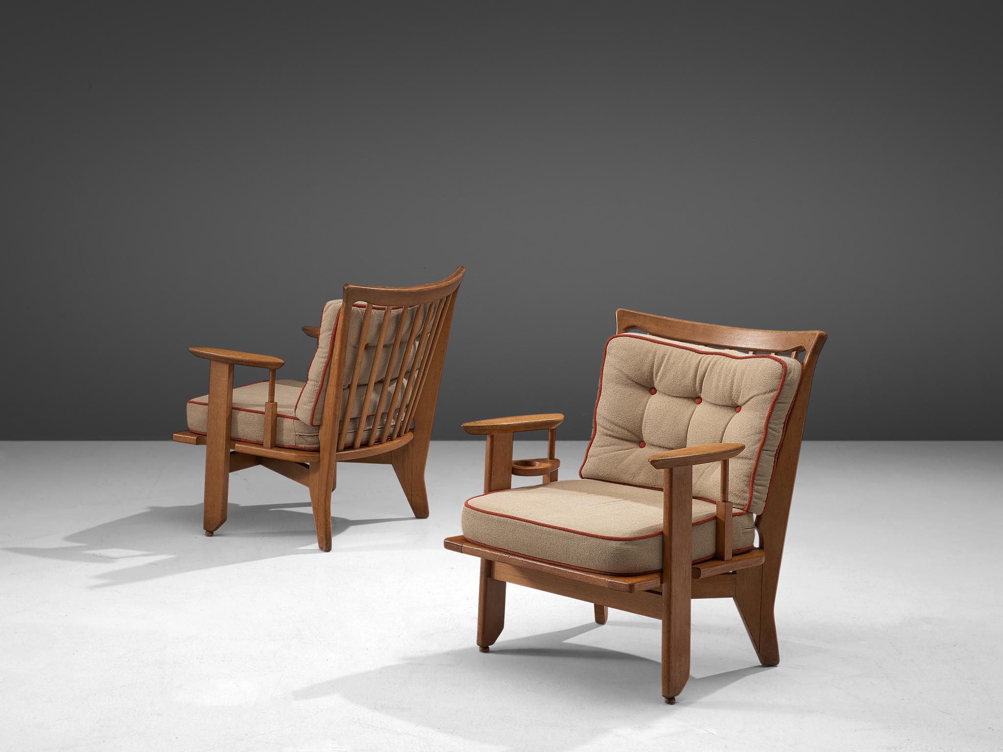 Guillerme and Chambron, pair of lounge chairs, fabric, oak, France, 1950s

These sculptural easy chairs are designed by Guillerme and Chambron and feature striking armrest. The duo is known for their high quality solid oak furniture, of which this
