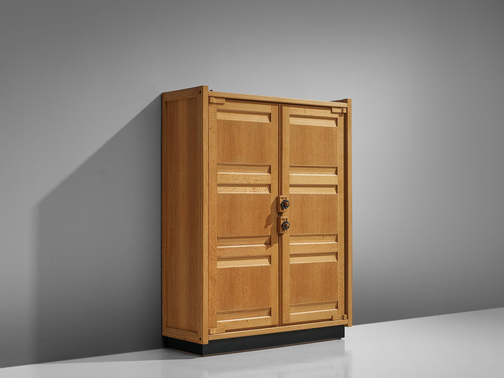 Guillerme et Chambron, armoire, oak, France, 1960s.

This case piece is designed by Guillerme and Chambron and features geometric oak inlays, creating horizontal panels on the front of the cabinet, which is characteristic for the French duo. The