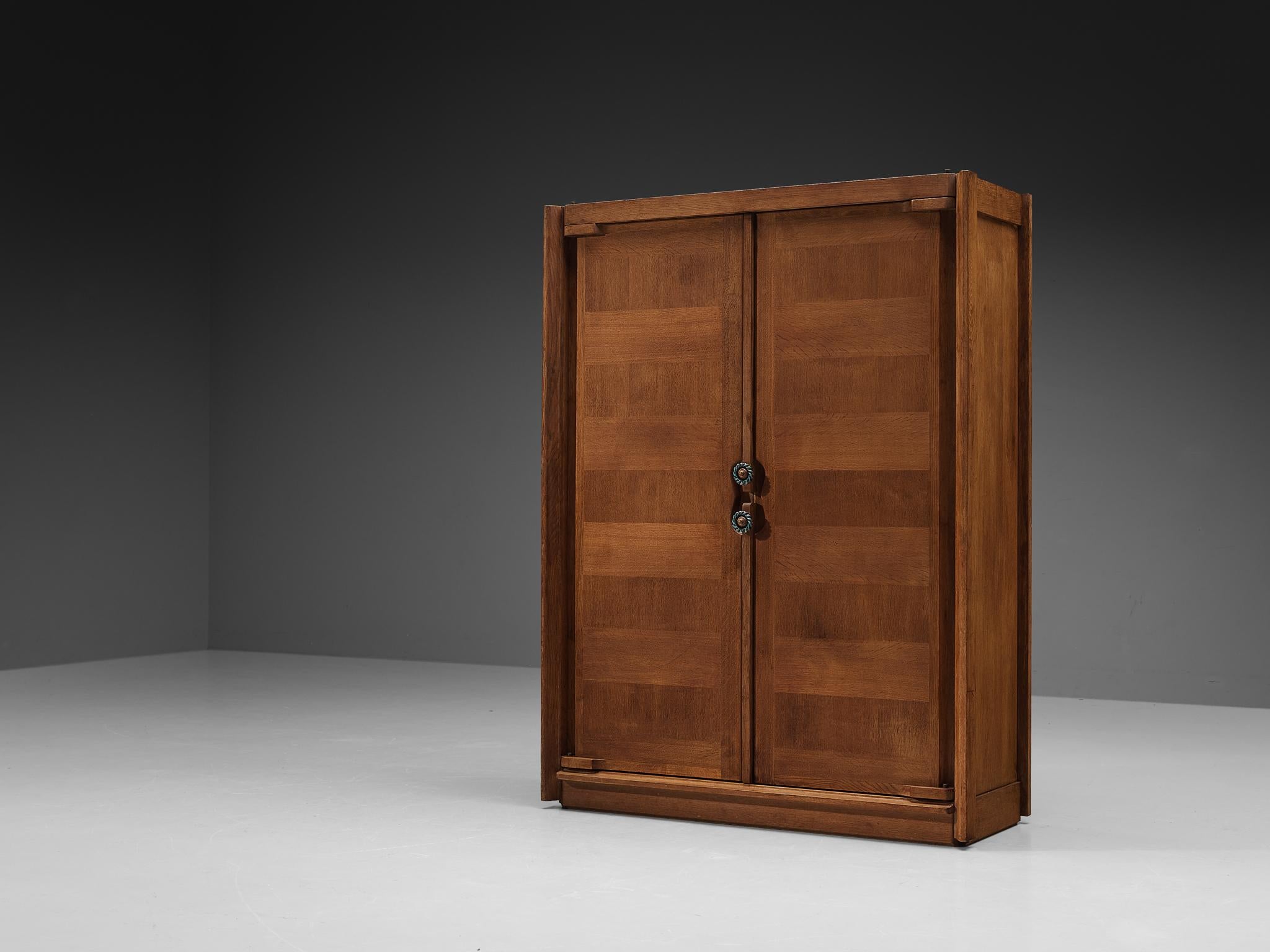 Guillerme et Chambron for Votre Maison, wardrobe, oak, ceramic, France, 1960s.

This armoire is a good example of excellent woodwork by virtue of the well-designed construction based on innovative wood joints and oak veneer marquetry, creating a