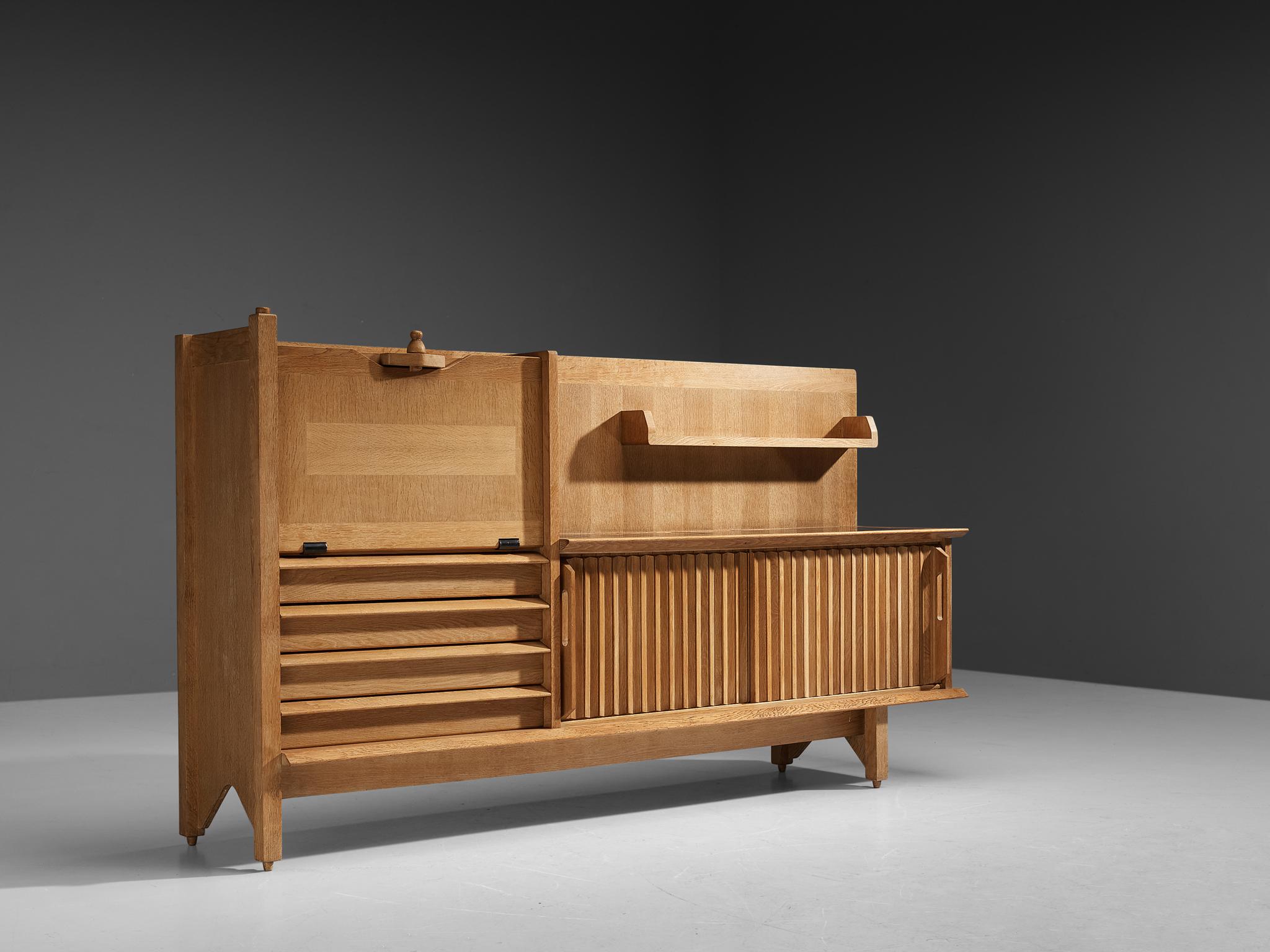 Guillerme et Chambron, buffet, oak and ceramic, France, 1960s

This characteristic cabinet in solid oak is designed by the French designer duo Jacques Chambron and Robert Guillerme. It features two sliding front doors, one pullout doors on the