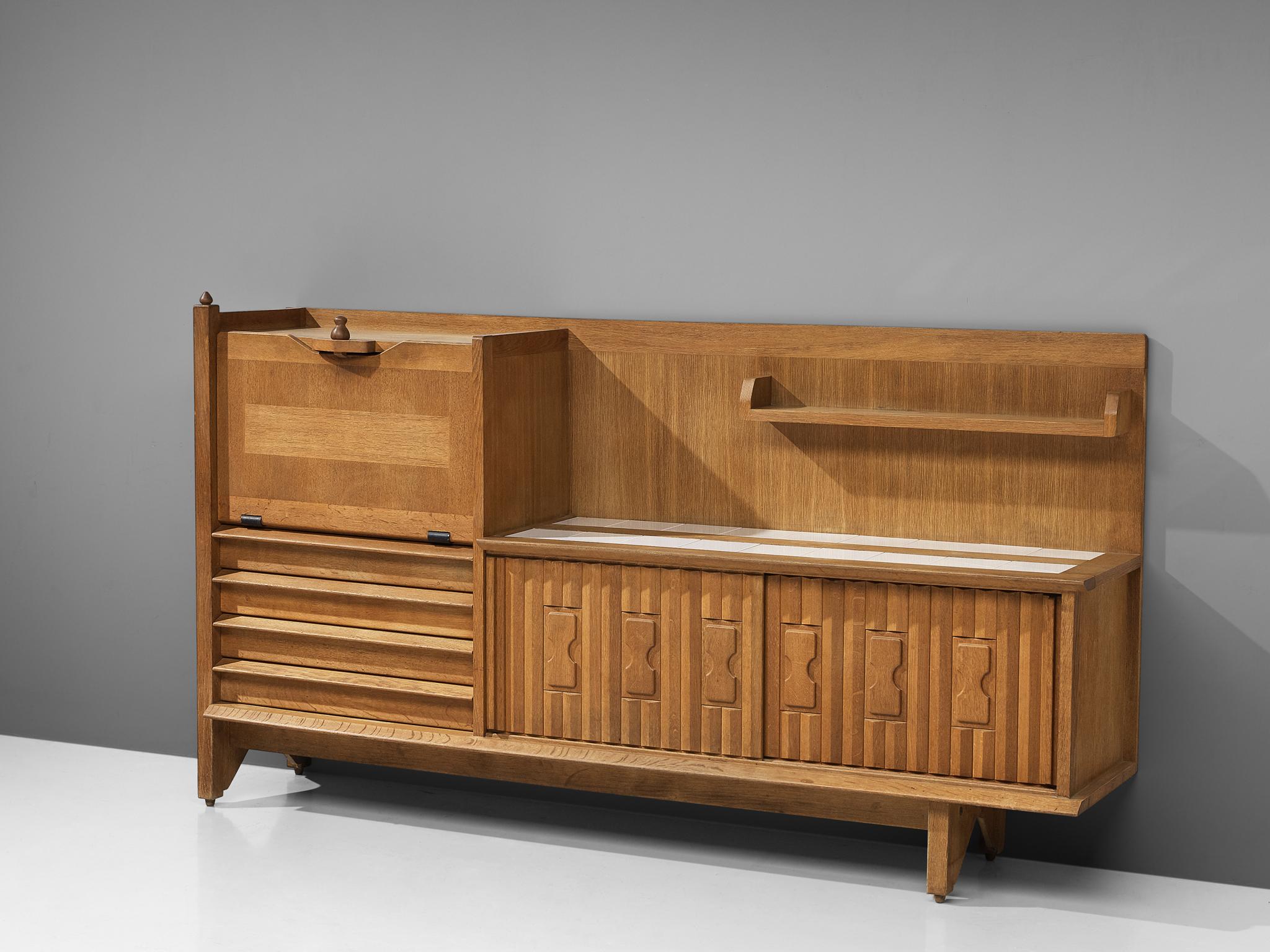 Guillerme et Chambron, buffet, oak and ceramic tiles, France, 1960s.

This characteristic cabinet in solid oak is designed by the French designer duo Jacques Chambron (1914-2001) and Robert Guillerme (1913-1990). It features two sliding front