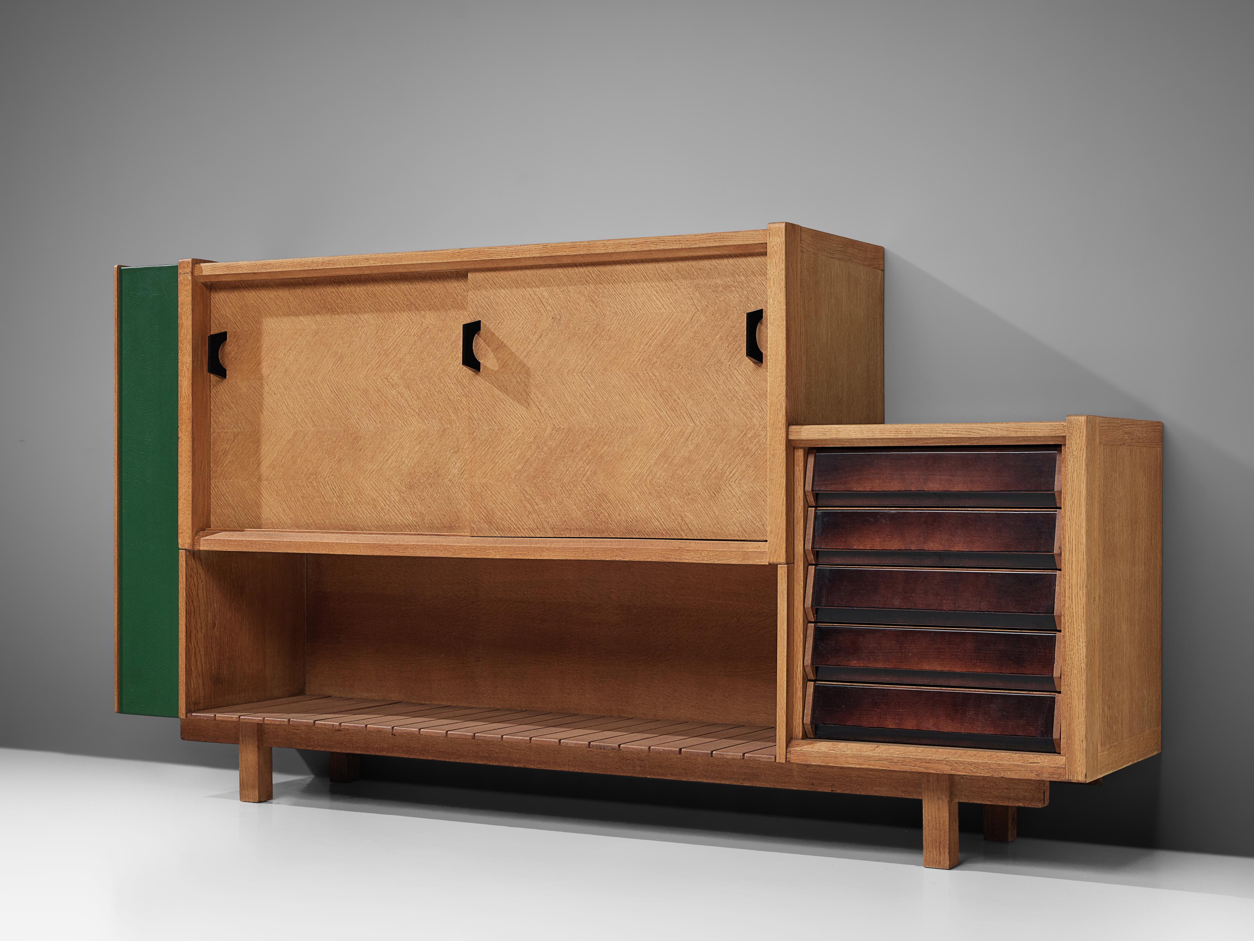 Jacques Chambron and Robert Guillerme, cabinet, oak, France, 1950s.

This sculptural sideboard by Guillerme and Chambron is very well executed and made out of blond oak wood. The oak has been inlayed into different angles, which creates a geometric