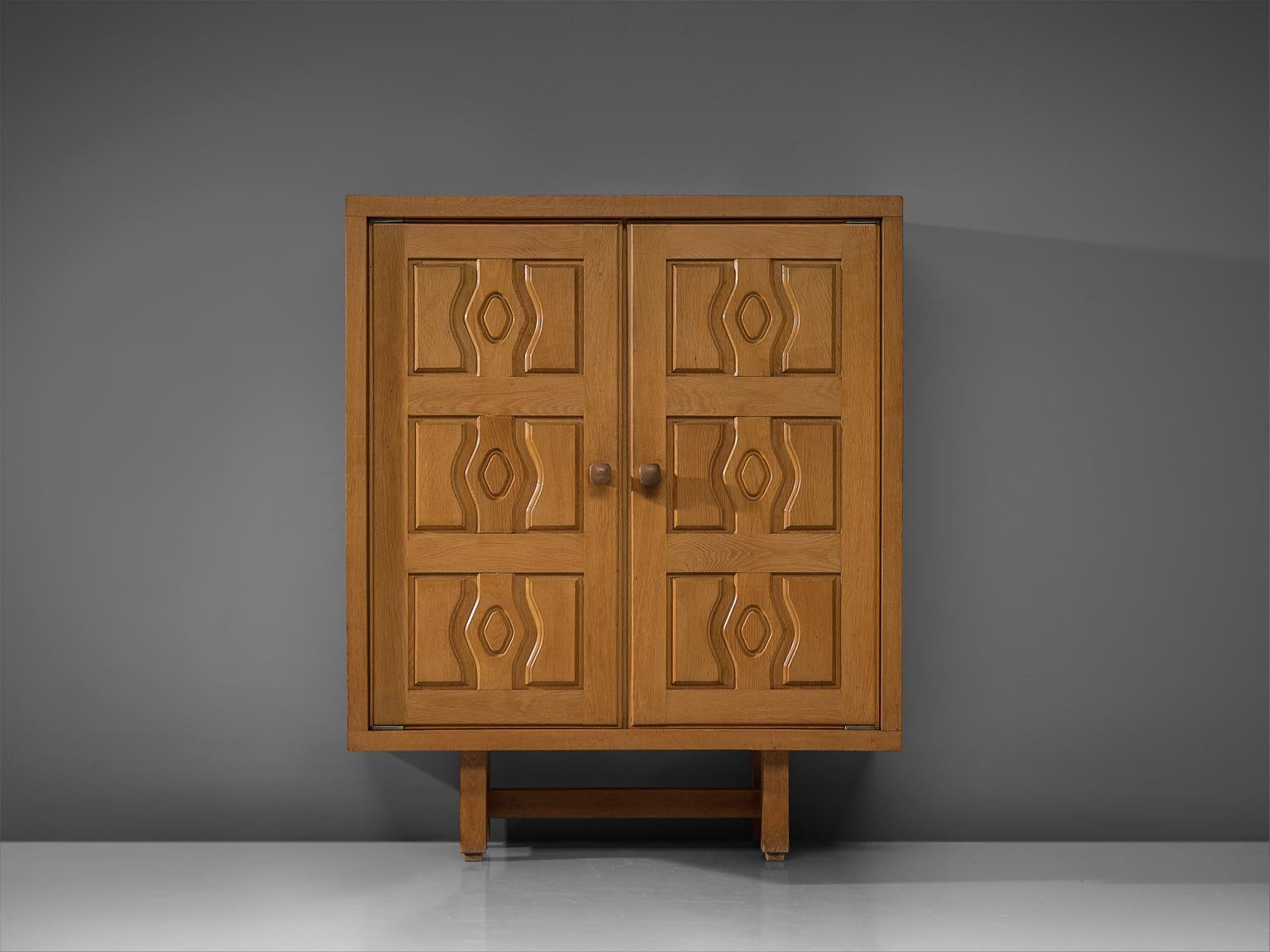 Guillerme and Chambron, high board, oak, France, 1960s.

This case piece is designed by Guillerme and Chambron and features geometric engravings in the doors that offers plenty of storage. The highboard contains characteristic handles for