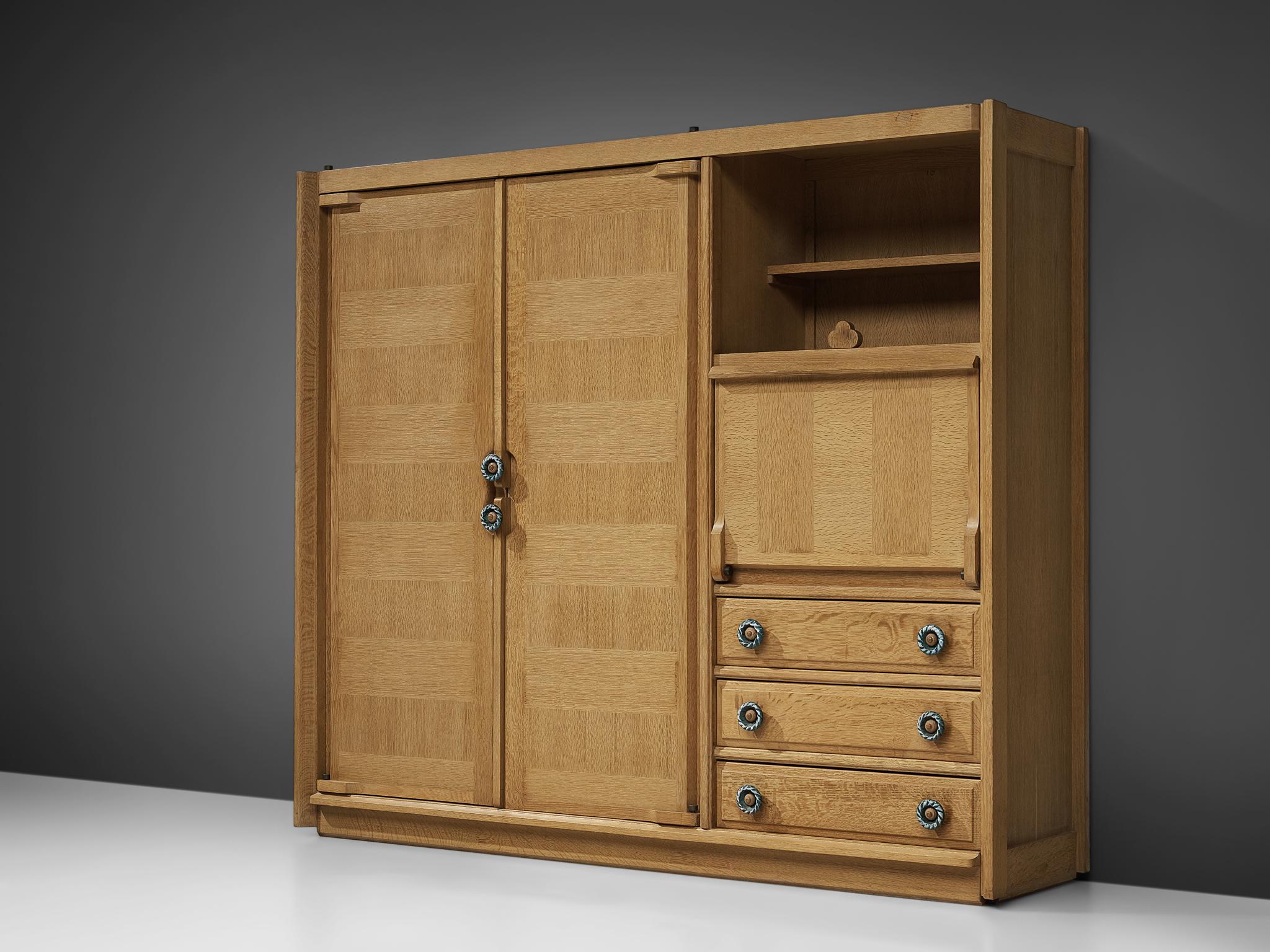 Guillerme and Chambron, highboard, oak, France, 1960s.

This case piece is designed by Guillerme and Chambron and features geometric engravings in the doors of the high part and few drawers at the lower part. The piece is typical for the design of