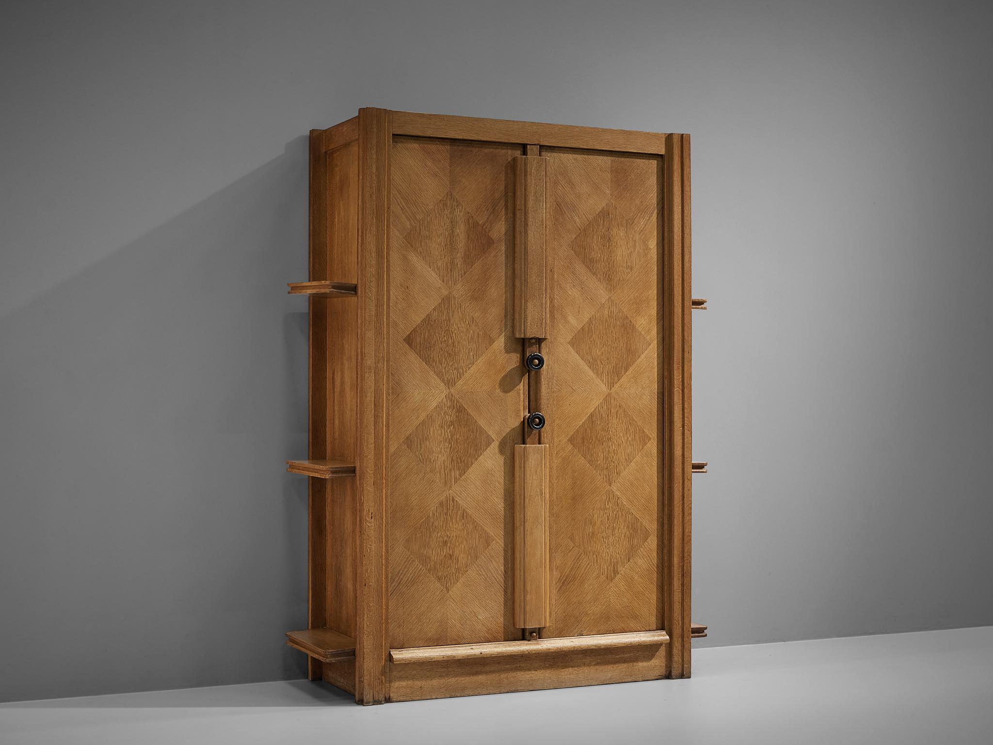 Guillerme et Chambron, cabinet, oak, France, 1960s.

This case piece is designed by Guillerme and Chambron and features geometric oak inlays, which is characteristic for the French designer duo. The center is accentuated with vertical slats as