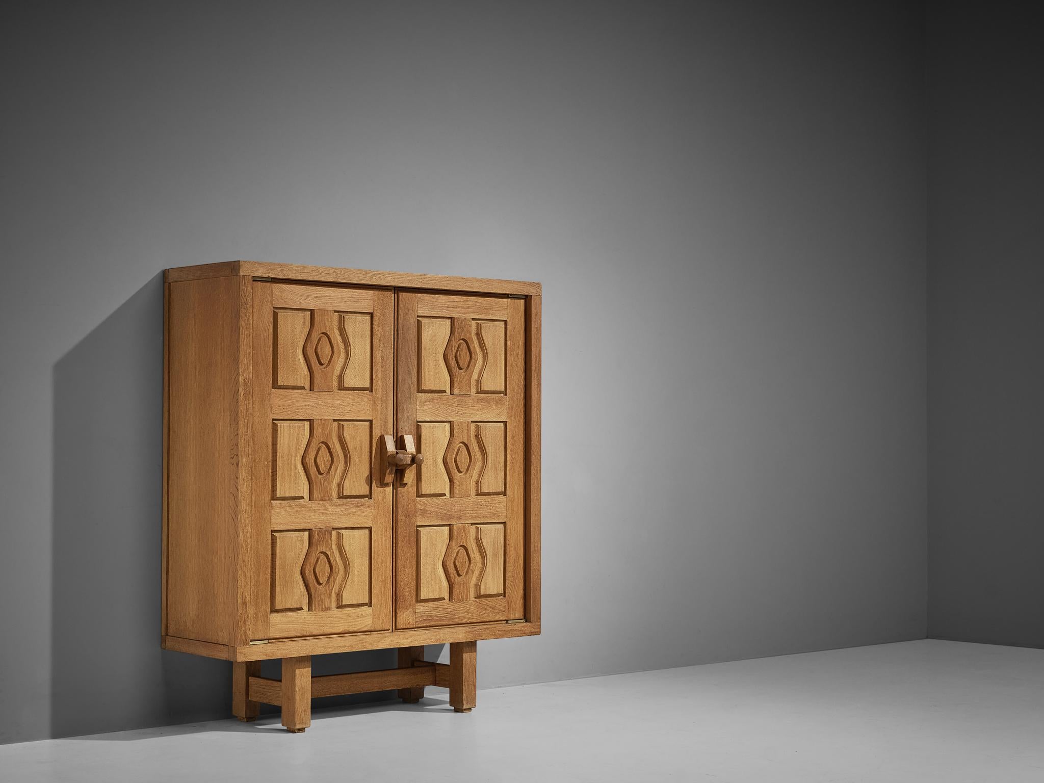 Guillerme and Chambron, high board, oak, France, 1960s.

This cabinet is designed by Guillerme and Chambron and features geometric engravings in the doors that offers plenty of storage behind them. The highboard contains characteristic handles for